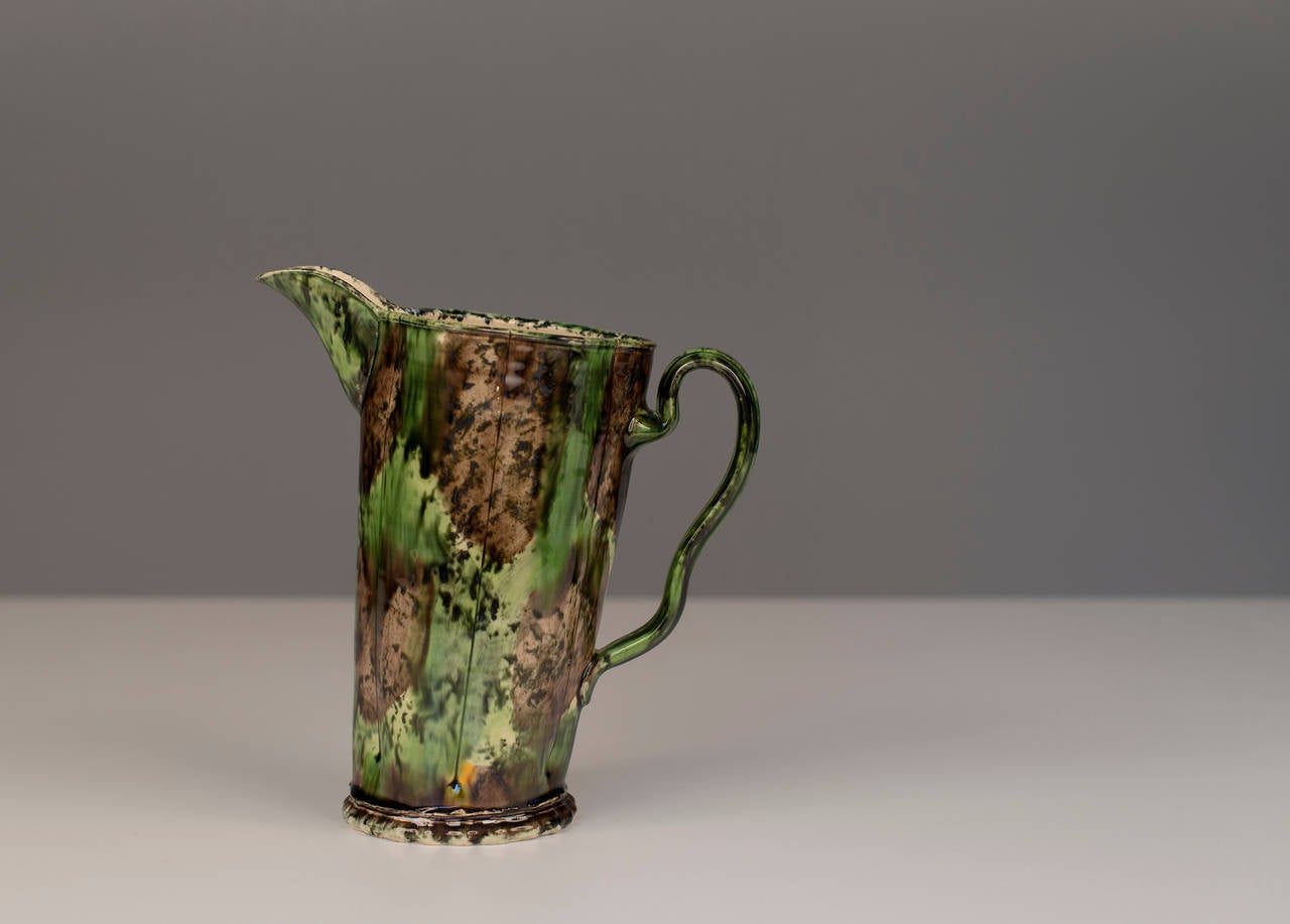 Earthenware glazed jug with potters mark by Walter Keeler.

16.5 cm tall (6 1/2