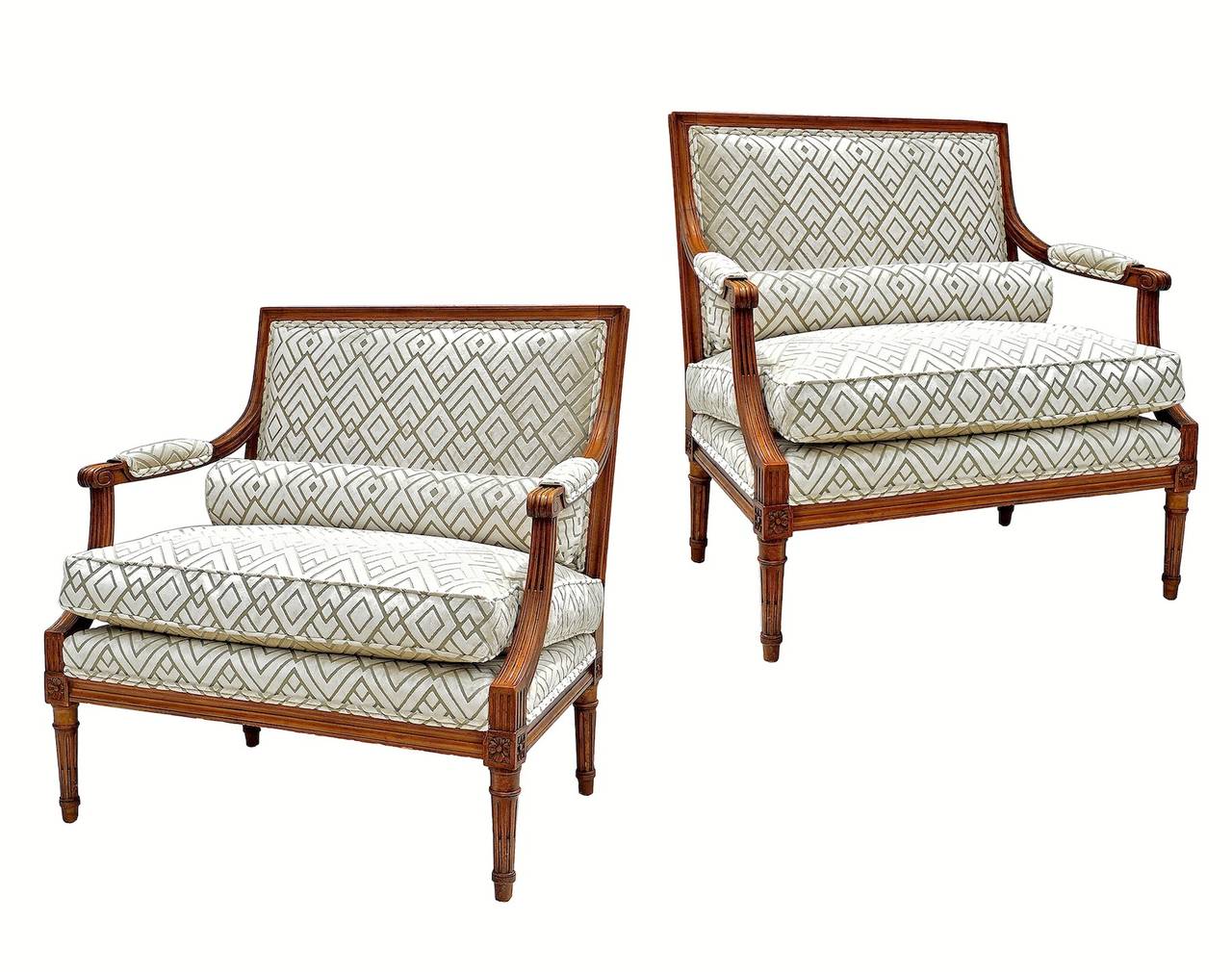 Pair of Italian made Marquise chairs in the Louis XVI taste circa 1940. Loose down cushions and round lumbar bolster pillows supply ample comfort to these stylish and striking petite settees. Fruitwood frames are very sturdy and show a high polish