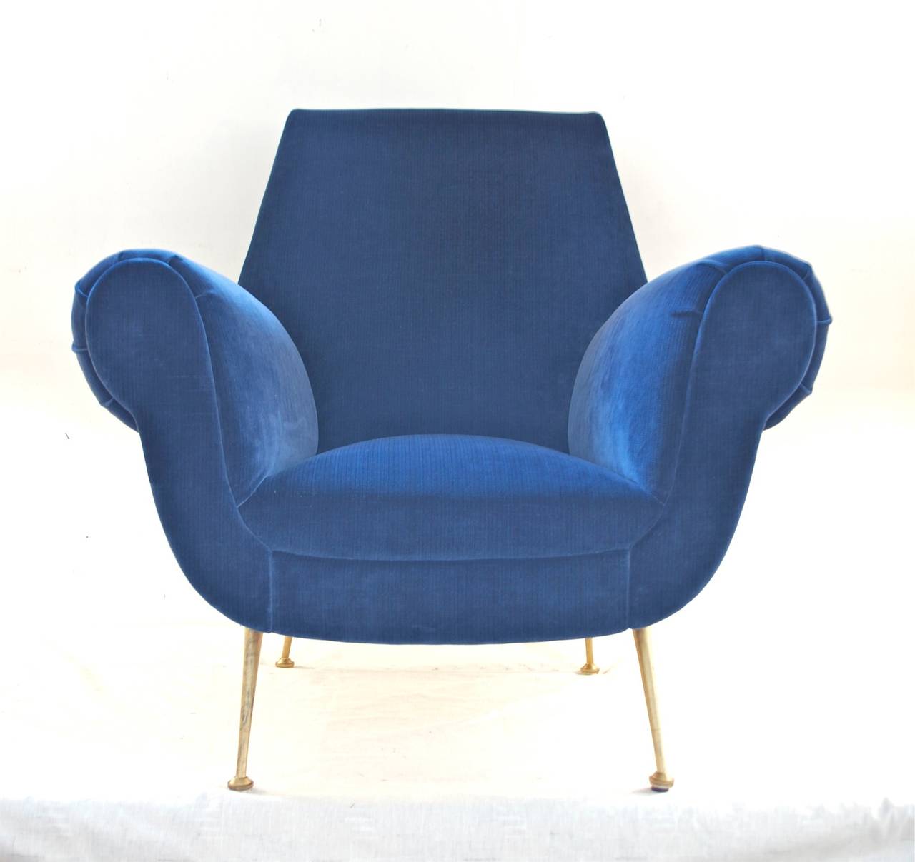 Sculptural Italian lounge chair attributed to Gigi Radice. The chair is dressed in a luxurious 100% cotton stried velvet of vibrant blue. Gilt metal legs provide steady support of the frame and complete the stunning look that this chair does possess.
