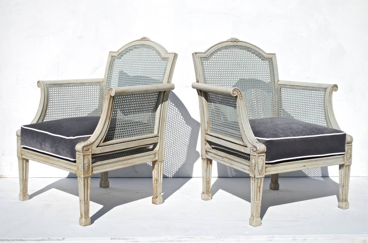 Pair of early 20th Century caned lounge chairs by esteemed firm A.H. Davenport. The chairs have been reconditioned, recently re-caned and recently painted and custom fitted with down wrapped cushions. The cabinet / furniture shop was formed in 1866