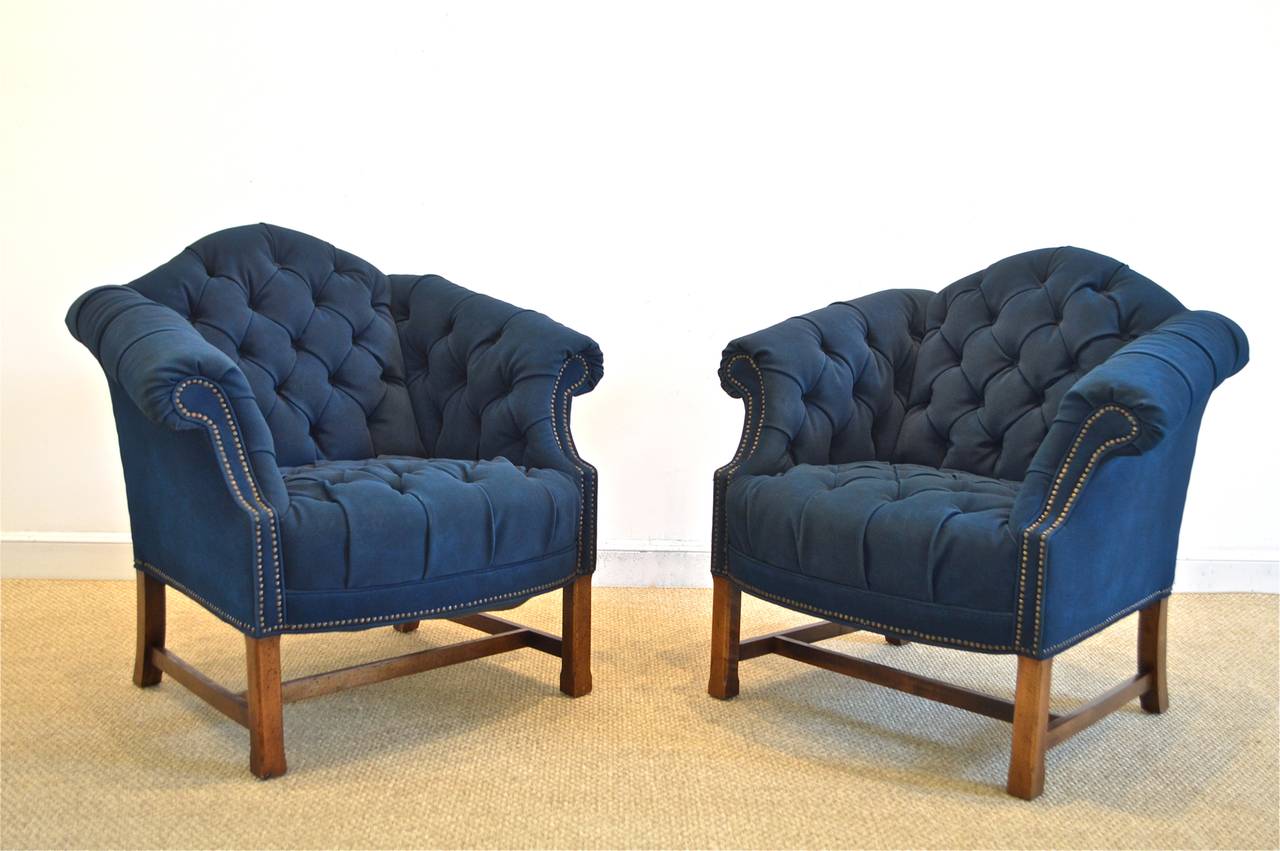 Chic pair of button-tufted club chairs of waxed canvas having spectacular nailhead trim adornment, resting on strong 