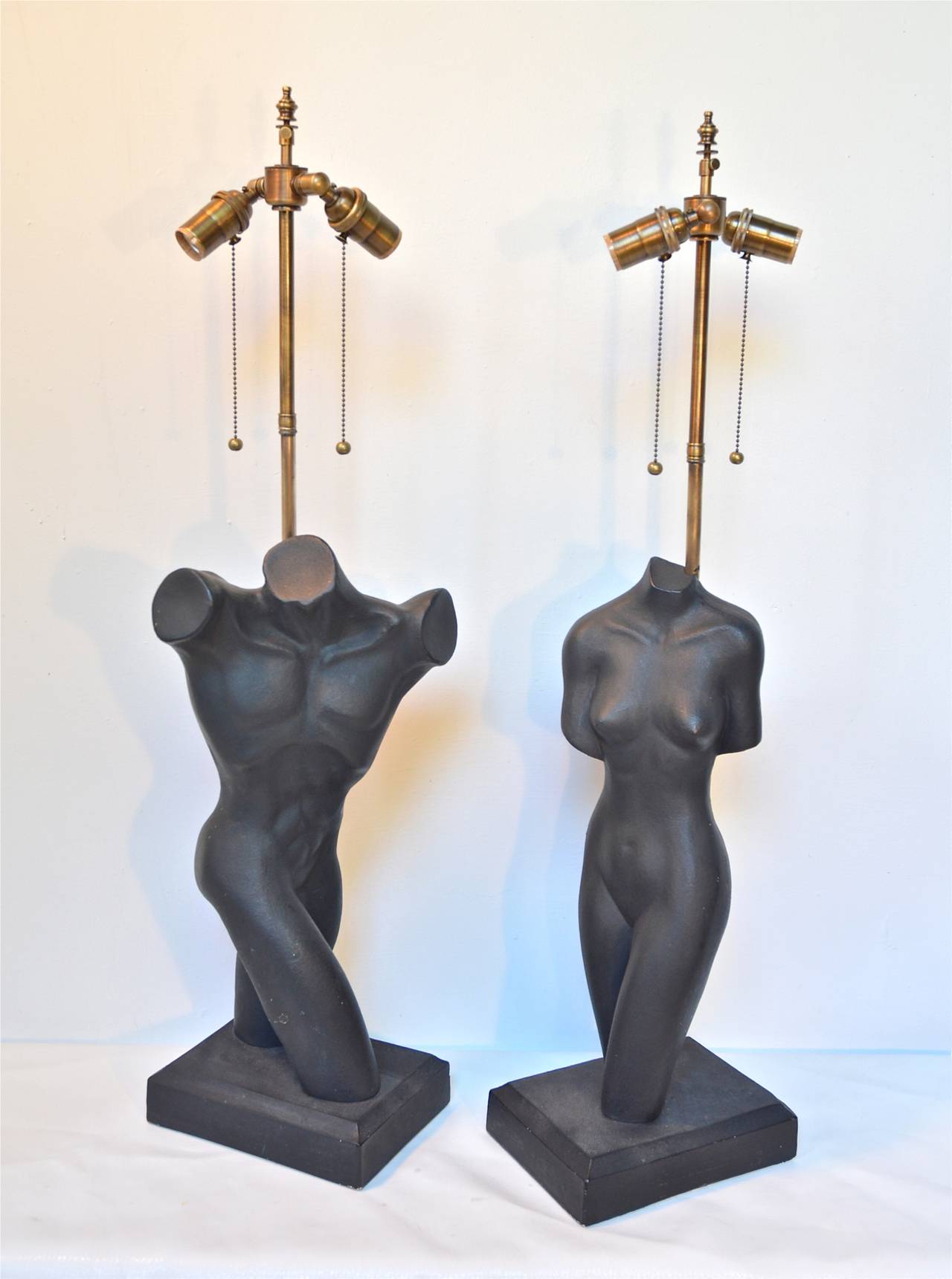 Pair of male and female figural formed lamps of plaster by Leo Middleman. Cast and produced in the early to mid-1950s by Sculptureline, New York, NY.
Original finish of a deep charcoal that resembles patinated bronze shows age and wear in an