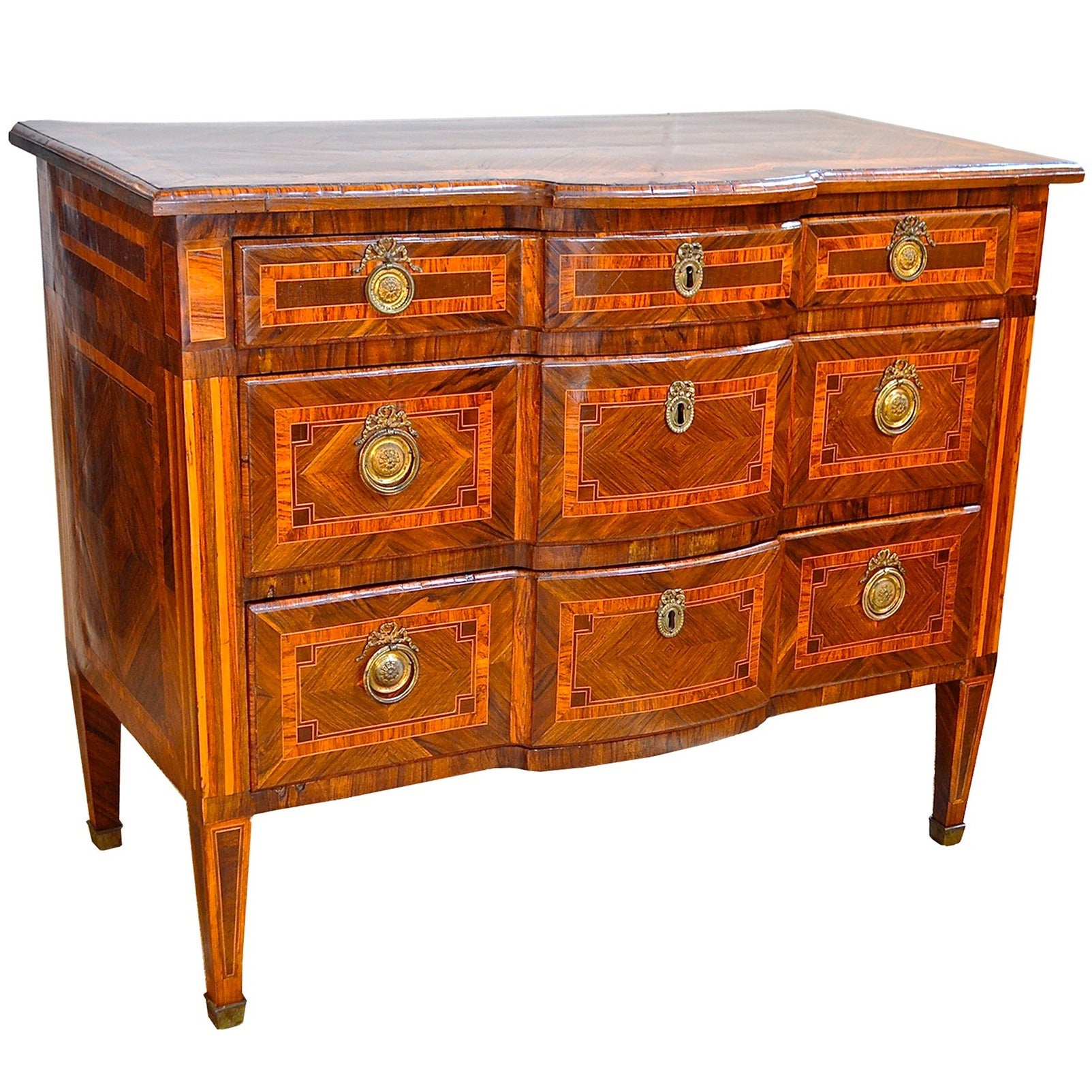 Stately and regal late 18th century neoclassical commode of rosewood. Inlays of tulip and birch are present along with the magnificent rosewood. Secondary woods of pine and walnut. Having masterfully inlaid marquetry work throughout, the simple yet