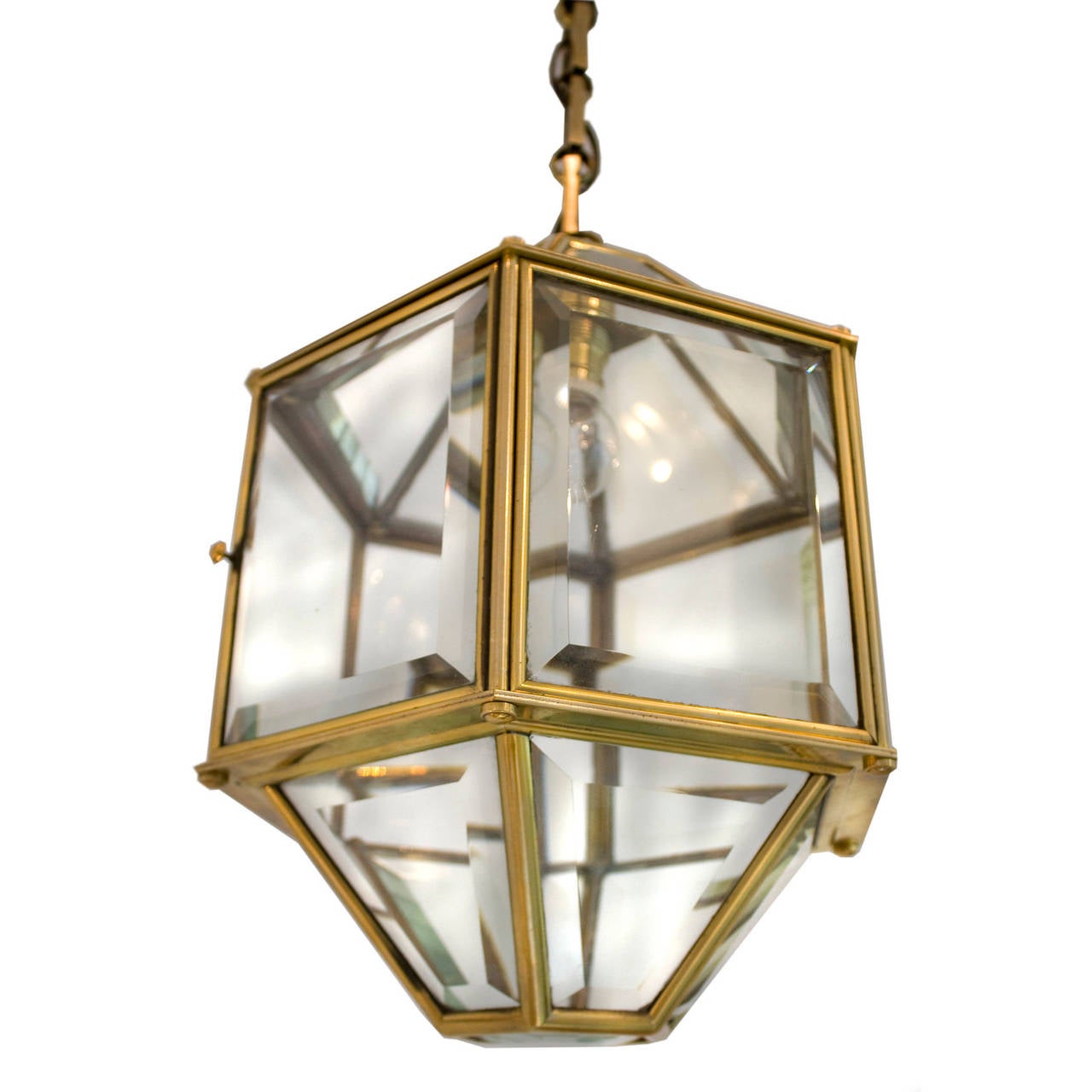 Stylish European brass lamp designed in the Adolf Loos Workshop. Original bevelled glass panels lamp with one square face hinged for opening. Original sleek brass chain, refined rectangular chain links, porcelain socket. Fully wired for standard