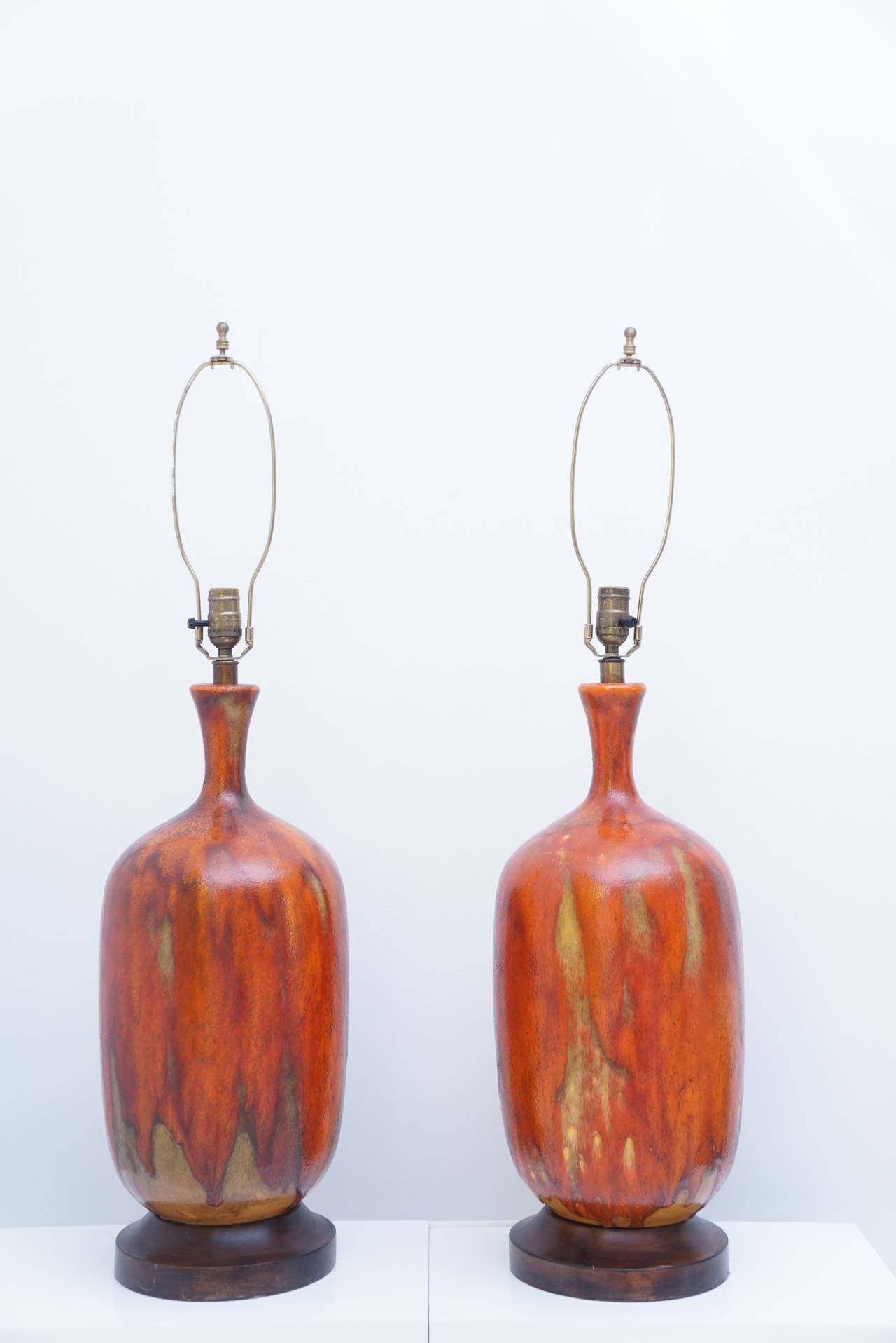 Pair of glazed mottled orange ceramic table lamps with Wenge wood base.