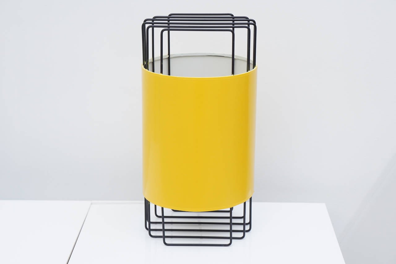 Black wire frame with yellow lacquer wrap around shade.