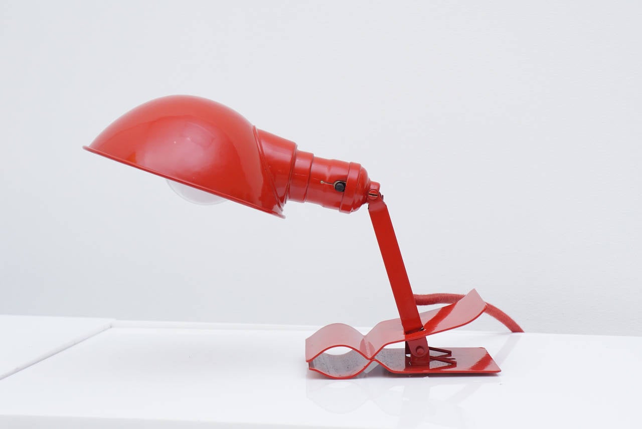 Vintage red lacquered adjustable clip-on reading lamp with red cord. 
When fully extended 13