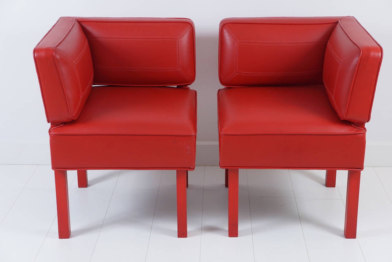Pair, custom red leather corner chairs with red painted wood legs.