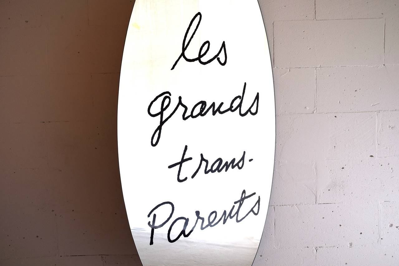 Designed in 1938 by Man Ray.

This elliptical mirror is serigraphed with “les grands trans-Parents.” A play on words written by Man Ray on a mirror, a poetical proposal for the home.

This mirror was originally made for Simon Gavina in 1971 and is