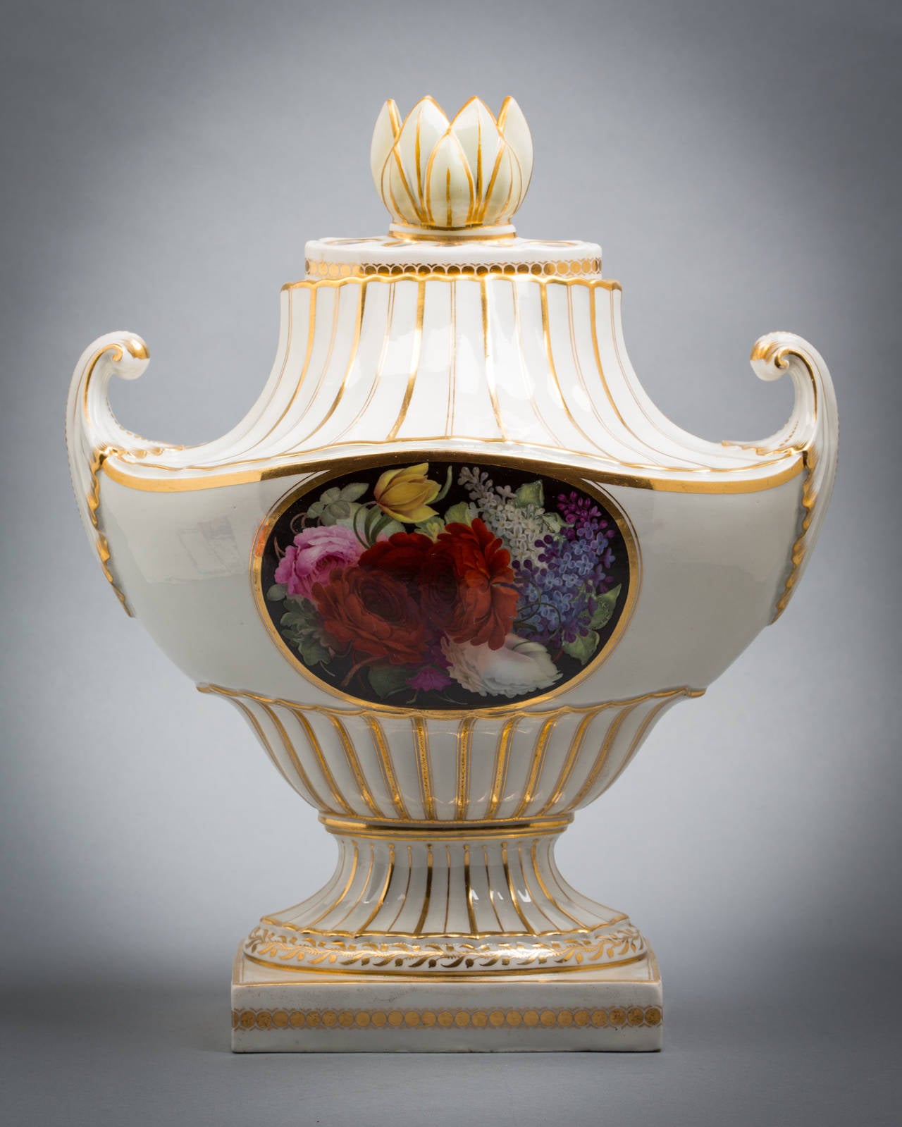 Rare English porcelain pistol-handled flight and barr covered vase, circa 1800.

Decorated on both sides with a floral bouquet. One one a aqua-blue ground (daytime) and on the other side on a black ground (nighttime). Inscribed on the base a puce
