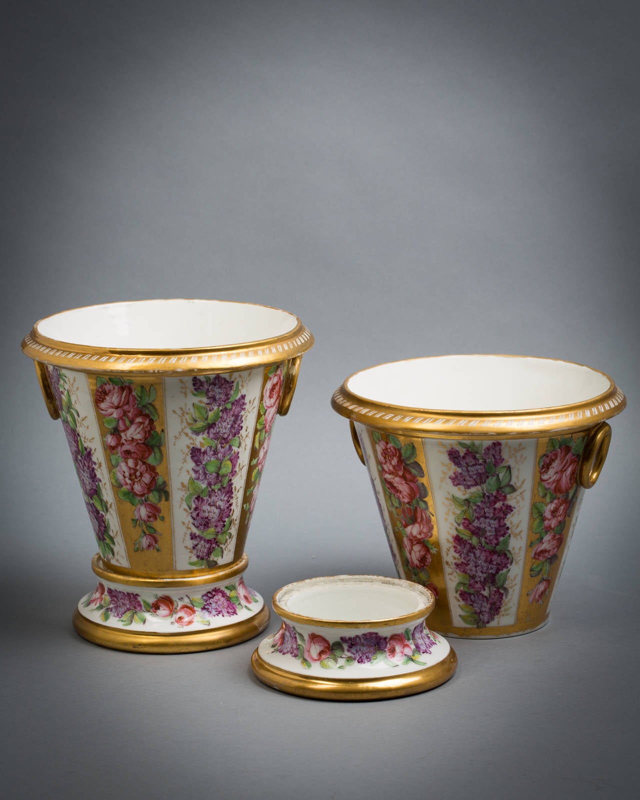 Pair of Paris porcelain cachepots and stands, circa 1820.