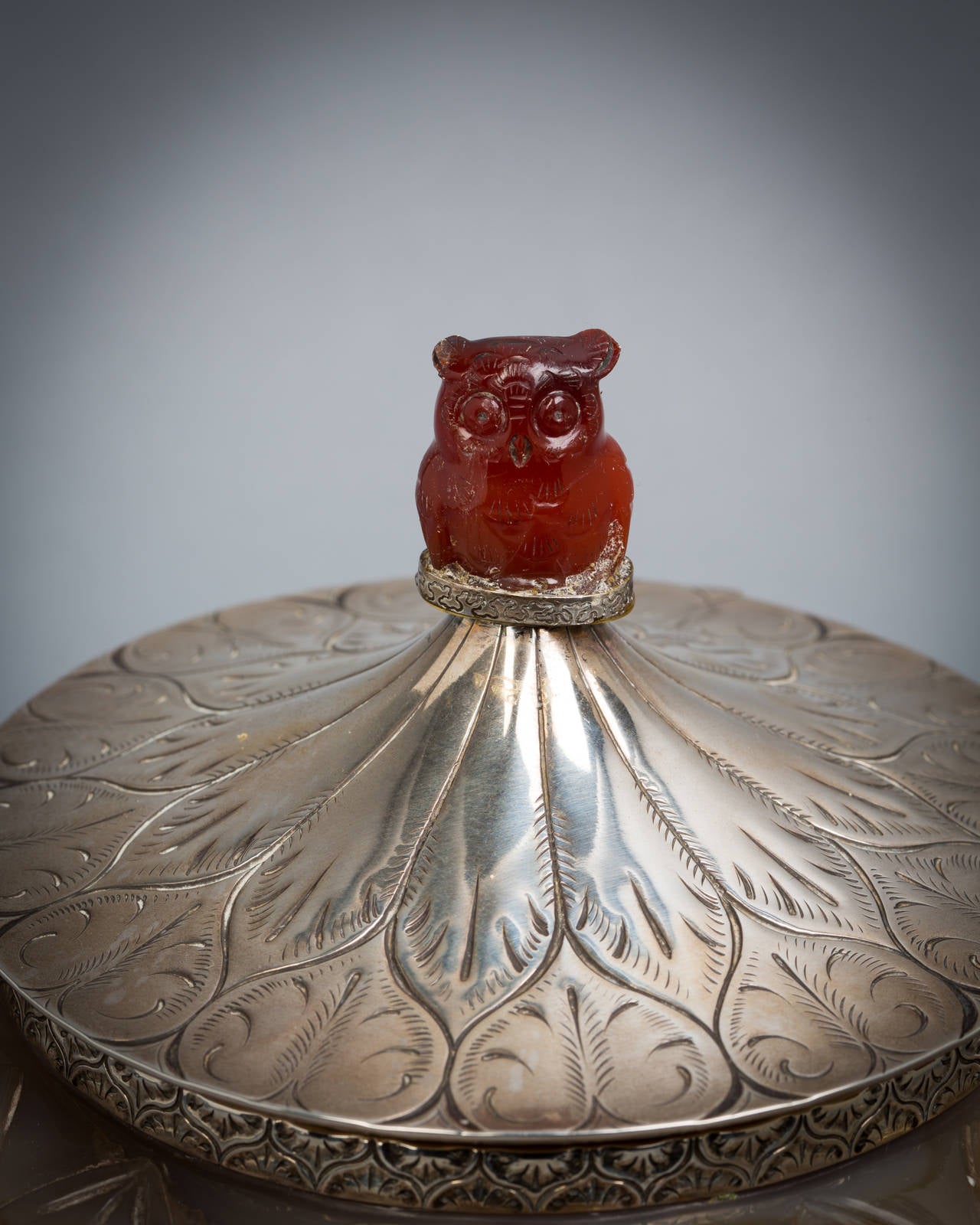 The Agate bowl is 18th century. This Chinese agate bowl was converted into a container with silver mounts and cover and a carnellion owl finial, circa 1900.

Although unmarked, we attribute the work as American based Upon the gauge, quality and