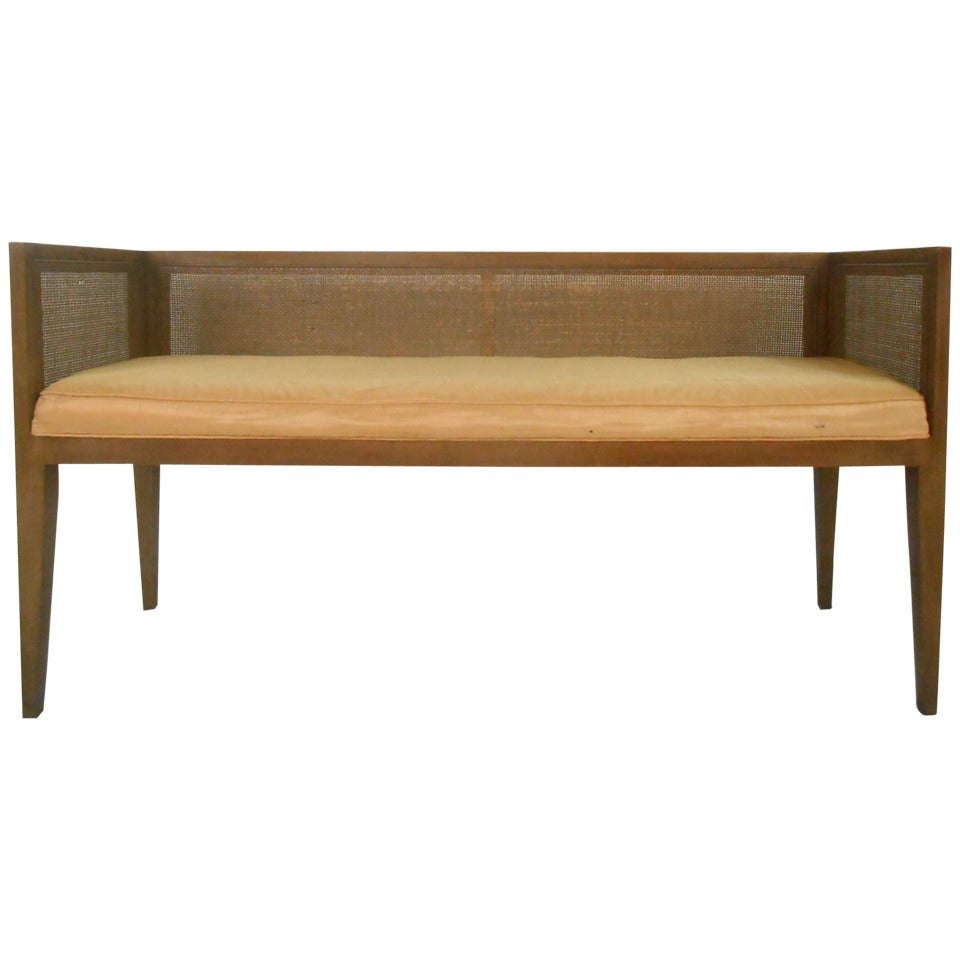 This midcentury window bench features a walnut frame, cane back or sides with upholstered seat. Please confirm item location (NY or NJ).