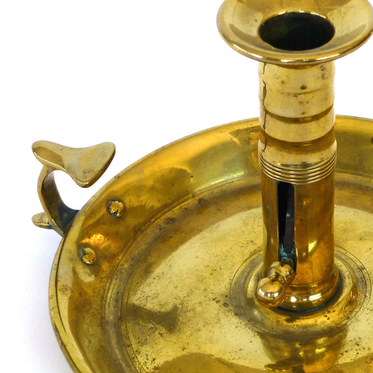 English brass chamberstick with flying scroll handle, circa 1790.