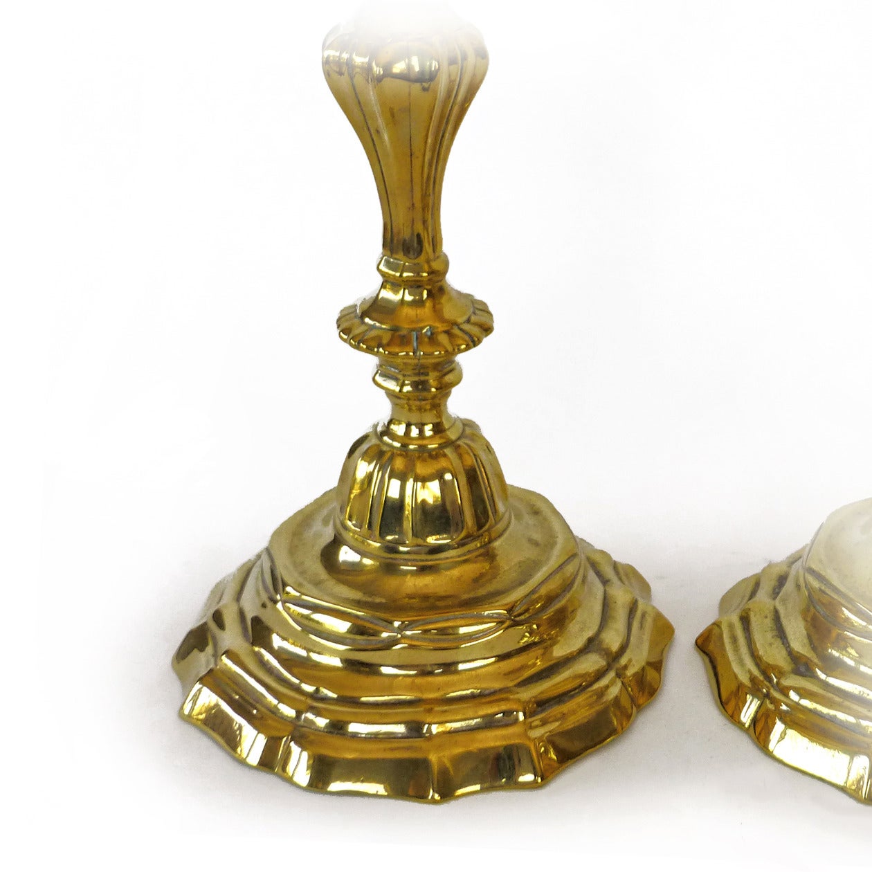 French “silver form” pair of brass candlesticks, circa 1745. Rare form with original bobeches. Seamed.