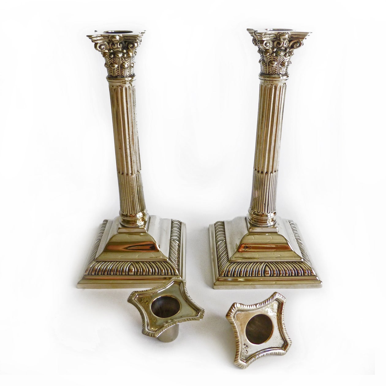 Pair of English Paktong Corinthian column candlesticks. Stop fluted gadrooned bases. Tooled out. Threaded connection. Sealed. Original bobeches, circa 1780. Not seamed.
