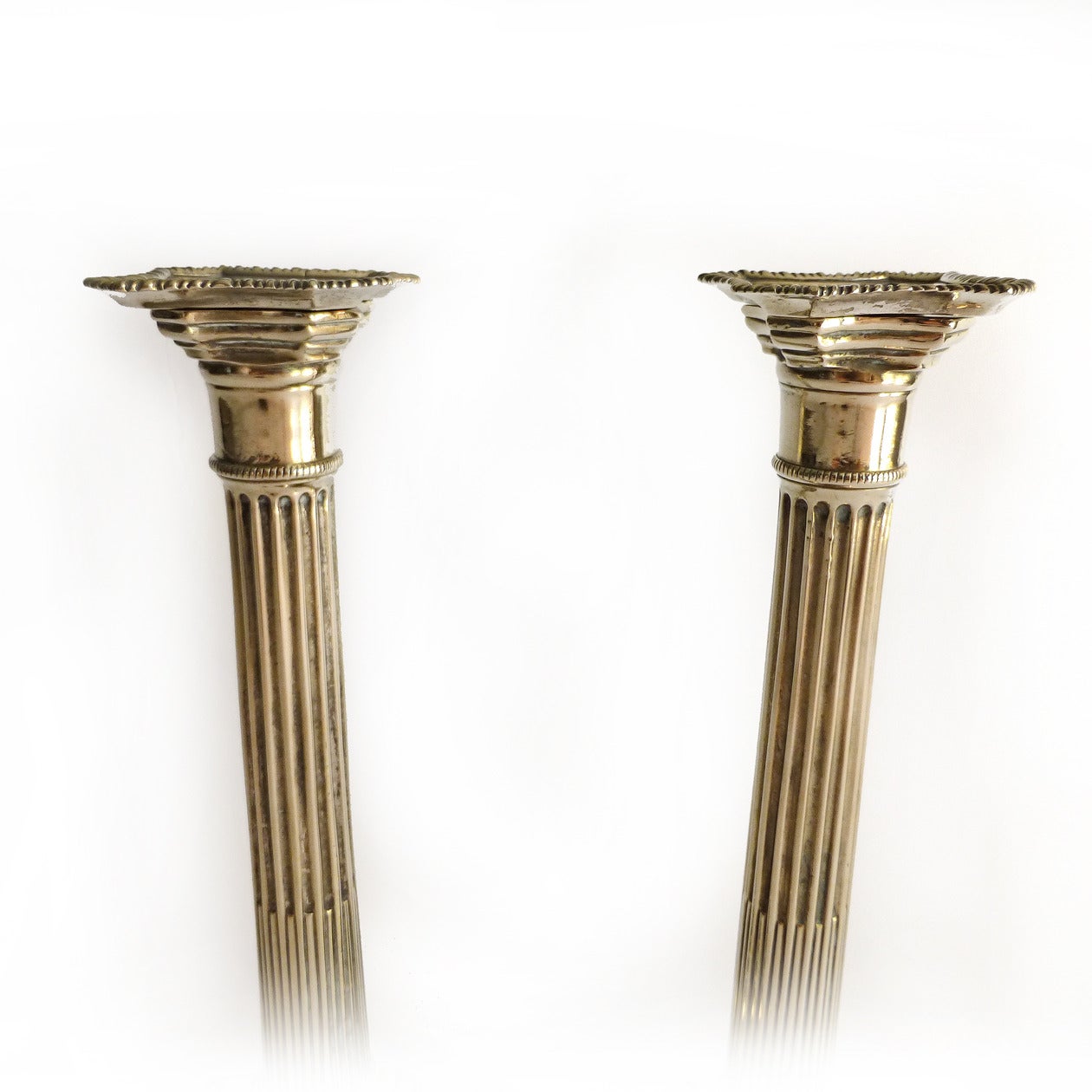 Very rare pair of English ionic column paktong candlesticks with original Bobeches. Remarkable pristine condition. Seamed shafts. Not tooled under base. Beaded and gadrooned, circa 1765.