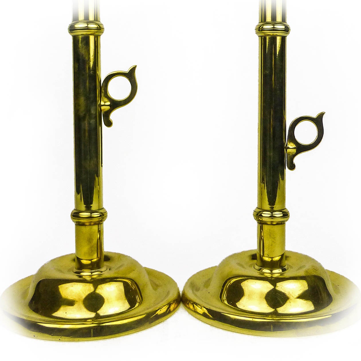 Tall pair of English Victorian brass side ejector pulpit candlesticks, circa 1850.

Single seamed construction with three “Wedding Bands.”

Measures: Height 20″, base diameter 7″.