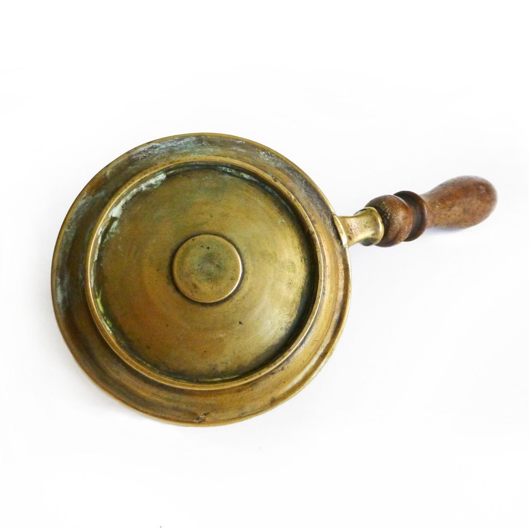 Rare single French brass chamberstick with wood handle. Seamed socket, circa 1740.

Length 7 ½”.

Height 1 9/16”.

Diameter of base 3 3/8”.