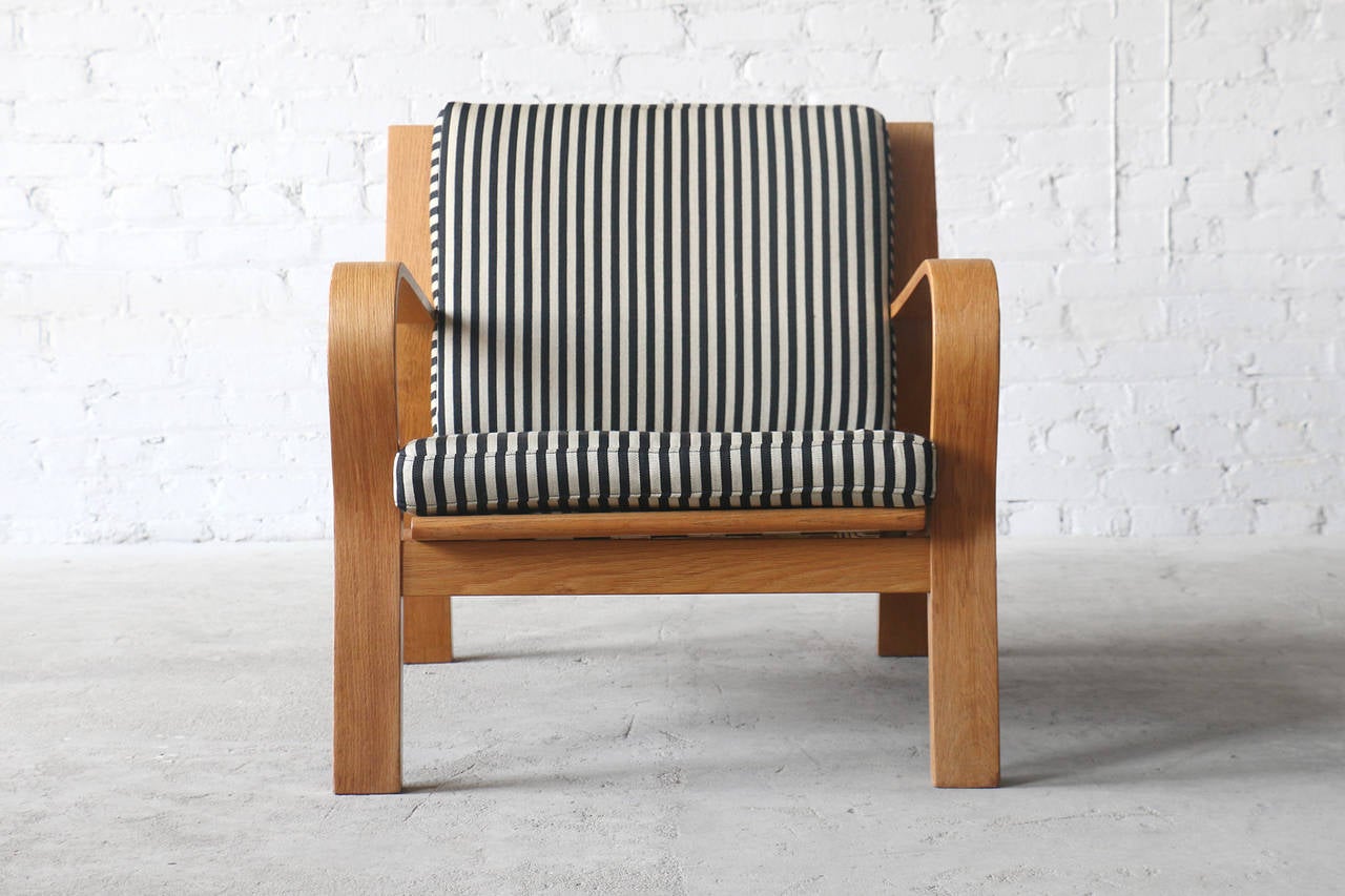 - model #GE671
- Designed in 1967
- bent wood oak frames
- flag halyard and webbing seat supports 
- striped wool fabric loose cushions

A terrific pair of easy chairs designed by Hans Wegner for Getama Gedsted. These chairs feature bent wood