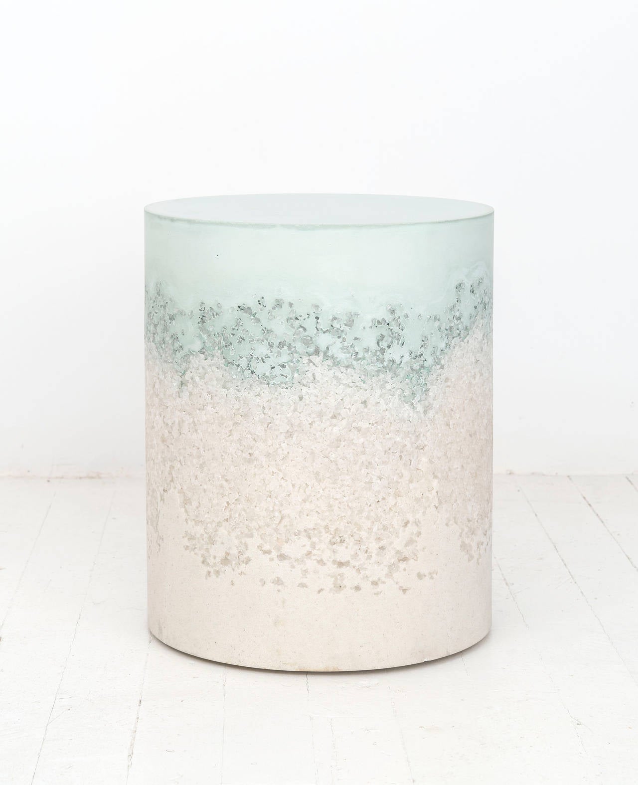 This made-to-order drum consists of a hand-dyed celadon cement top with a packed white rock salt center and a packed white sand bottom. The cement is poured by hand over the aggregates, creating an organic blend between the materials. The piece has