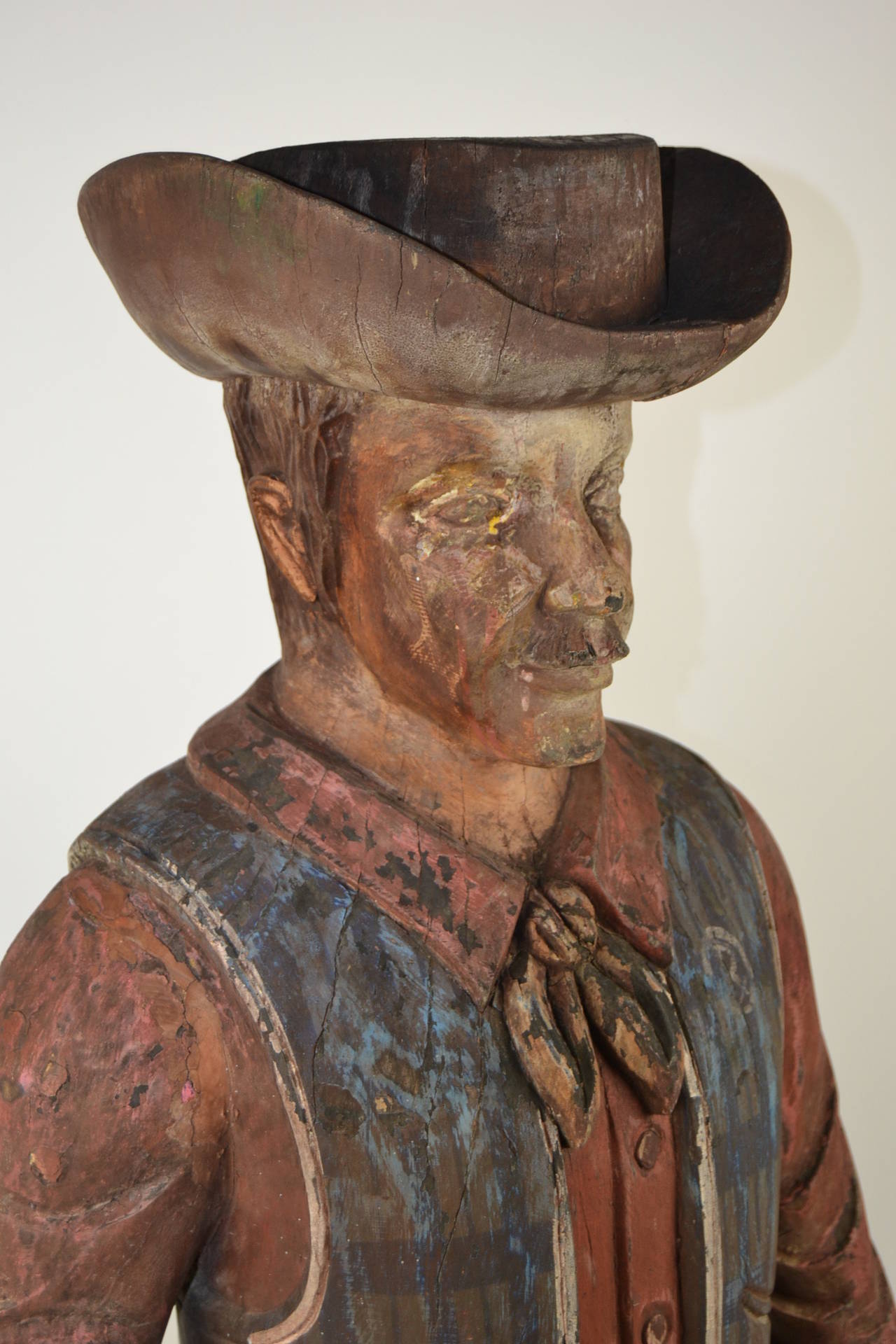 Old full size hand-carved wooden cowboy sculpture. Nice worn patina. Holding his hand on the gun ready to shoot the enemy. Western collectable.