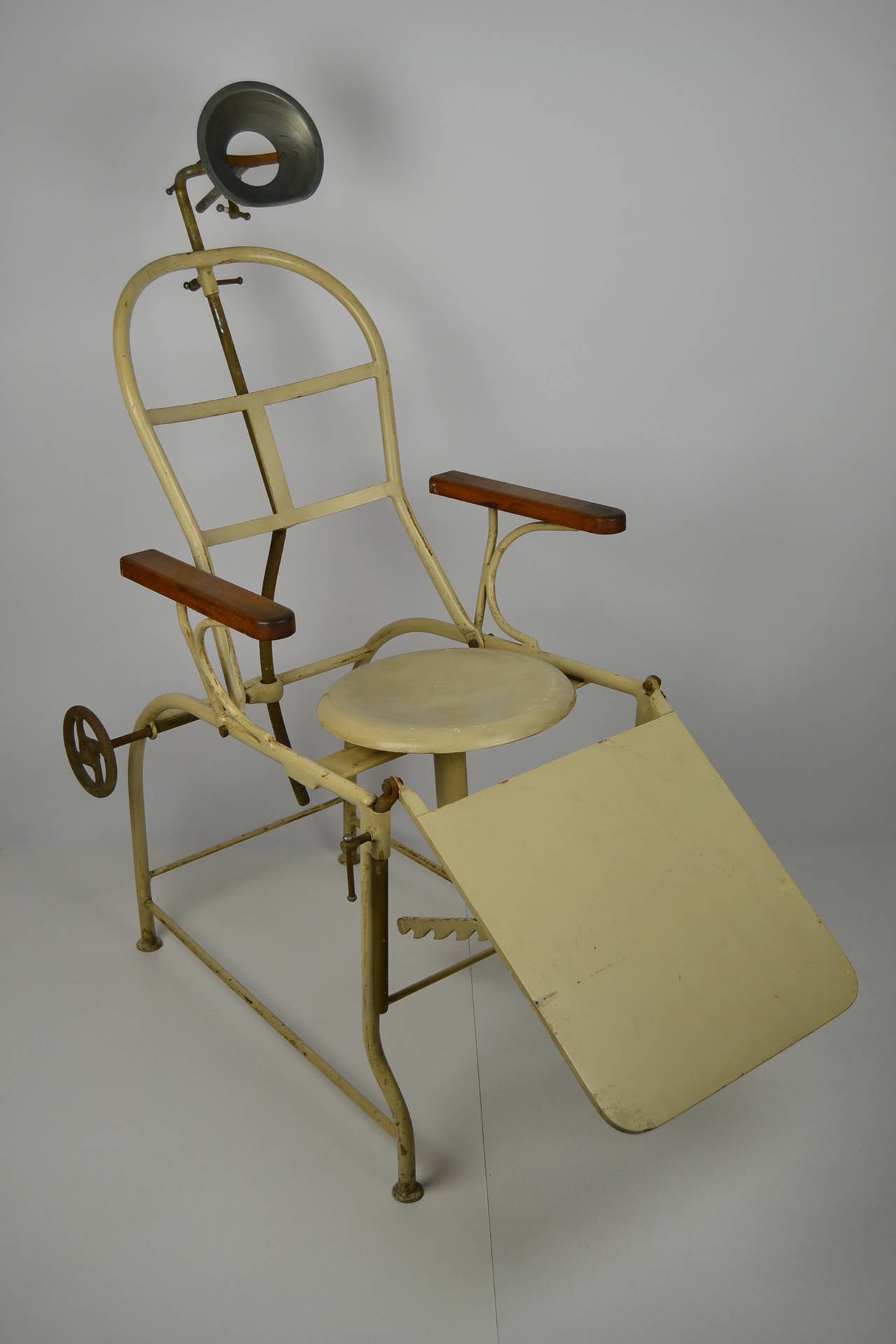 Real curiosity, antique portable medical chair, circa 1920. Exam or surgical chair for ophthalmologist or dentist, vintage hospital or doctor's equipment, cast iron, enamel painted, wooden armrests, headrest, seating and back adjustable.
Complete