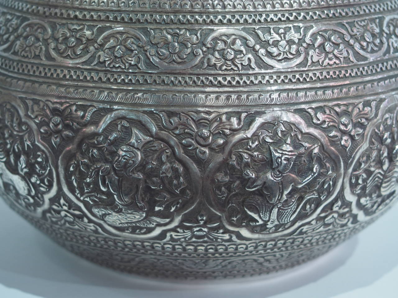 The Burmese silver bowl was traditionally used for ceremonial or offering purposes but not confined to religious use.  It is finely engraved with embossed signs of the Zodiac, enclosed by close-knit foliage chased in low relief, and hand made in