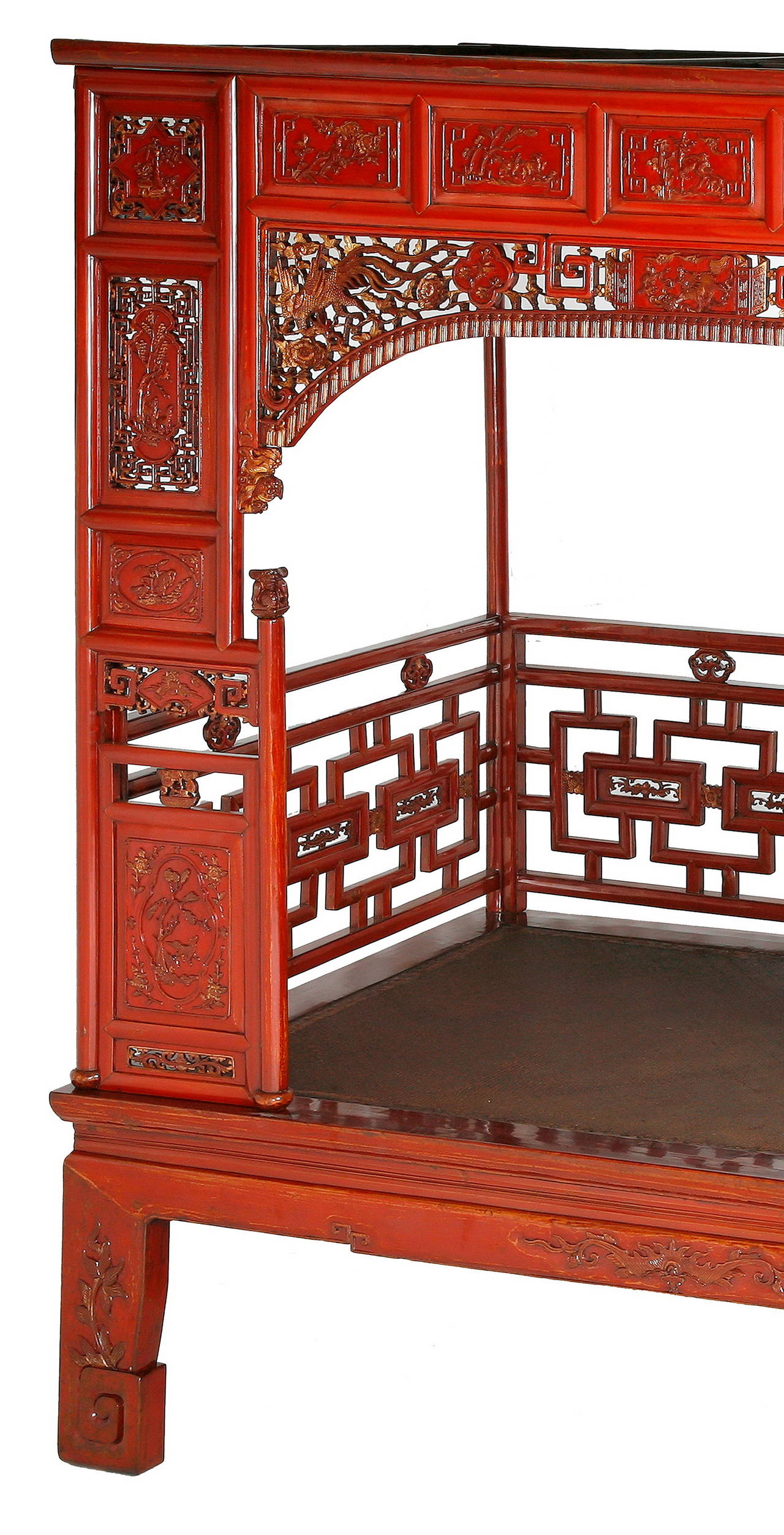 The exquisite canopy bed featuring a base with a waist, ice-plate edged frame enclosing a woven top, aprons and feet relief-carved with floral and reticulated scroll work, six posts forming the frame for the railing and canopy, decorated with panels