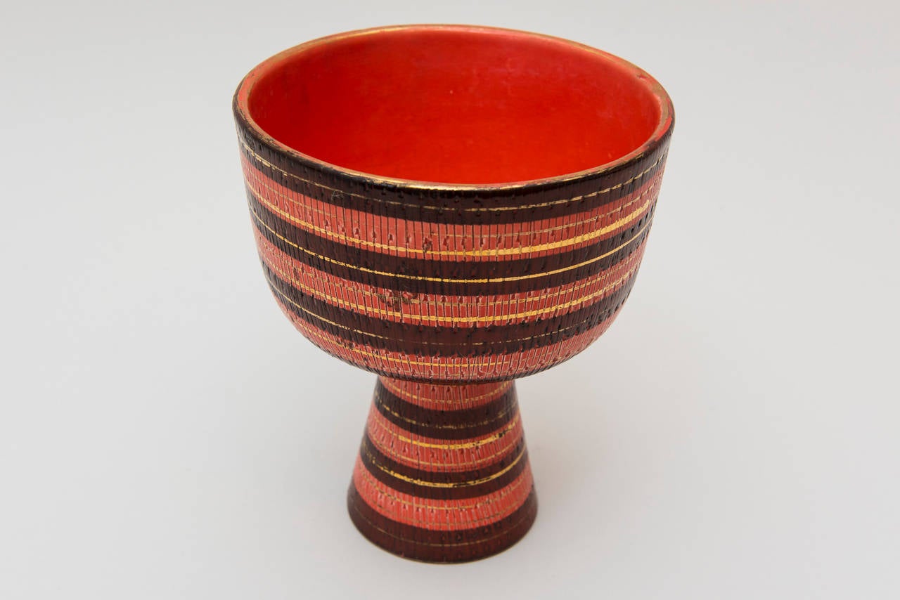 Colorful Bitossi coupe or footed bowl with chic maroon on coral stripes for Raymor. Beautiful glazes, along with gilt and incised detailing make this a very special piece. Signed to underside with 