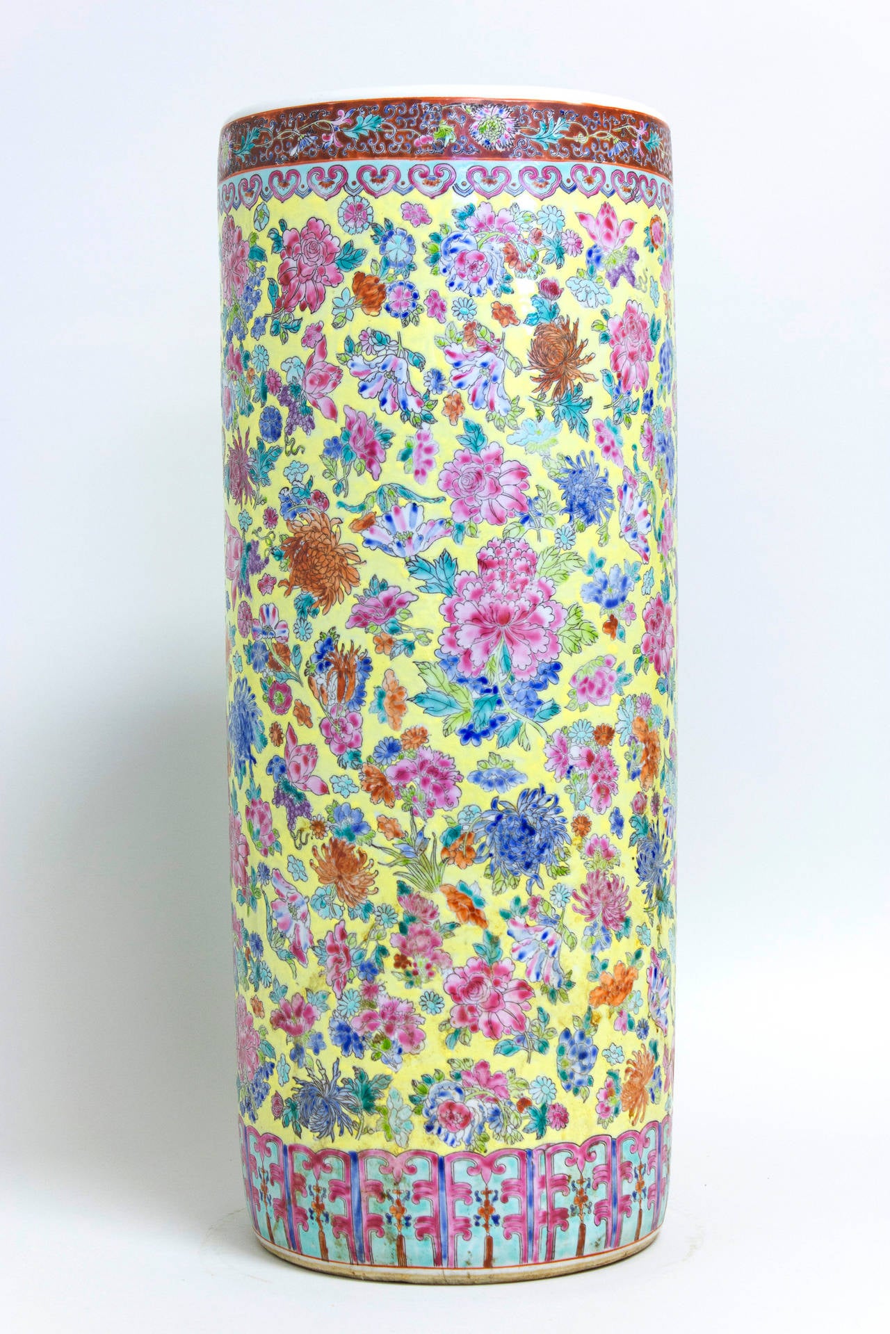 Oversized ceramic cylindrical vessel, probably Chinese, 1950s. Hand-thrown and painted, the craftsmanship is excellent. Exterior with yellow background and colorful floral decoration as well as decorative banding around the top and bottom rims.