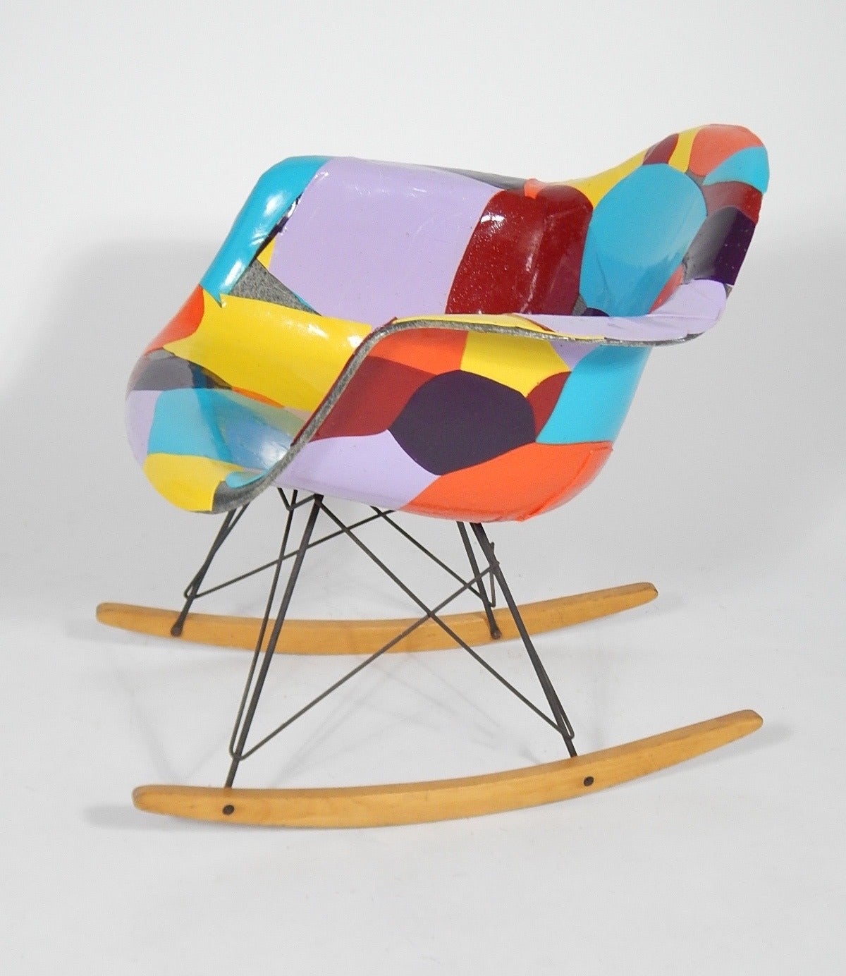 An original and early fiberglass elephant grey rocker by Charles and Ray Eames for Herman Miller, circa 1950s updated by artist Jim Oliveira in acrylic gloss medium, signed and dated 2005, titled 