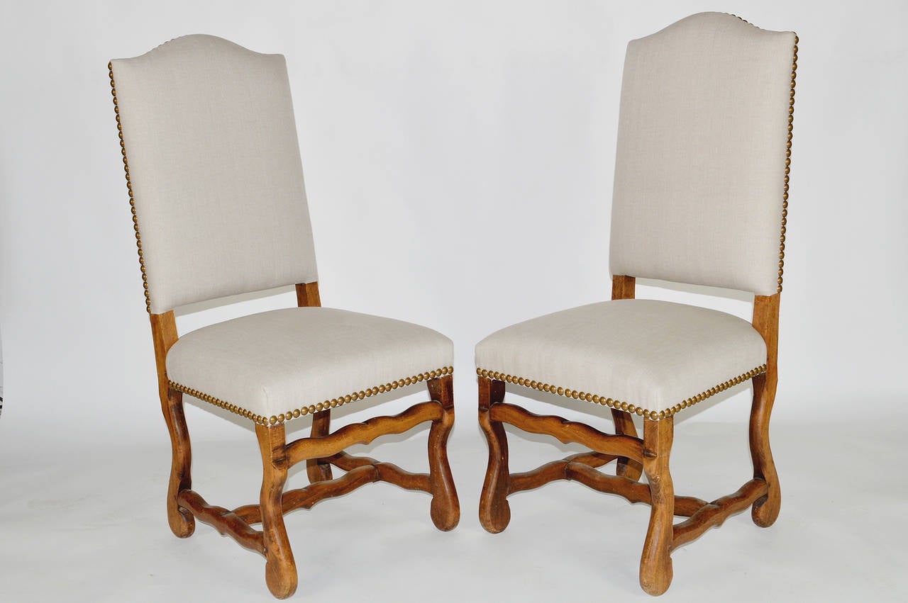 A Beautiful Set of six French Louis XIV style dining chairs. Covered in New Linen with nail head trim.