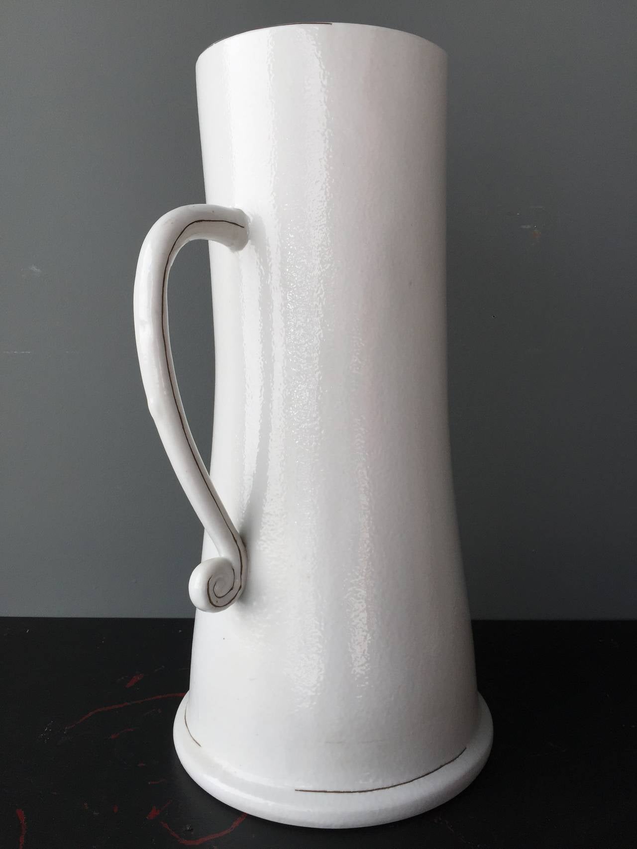 Place this on the floor with umbrellas or on the table with cream - either way it is a totally gorgeous object.  This possible Italian or French ironstone pitcher form has wonderful scale.  There's a great line detail painted on the foot, handle and