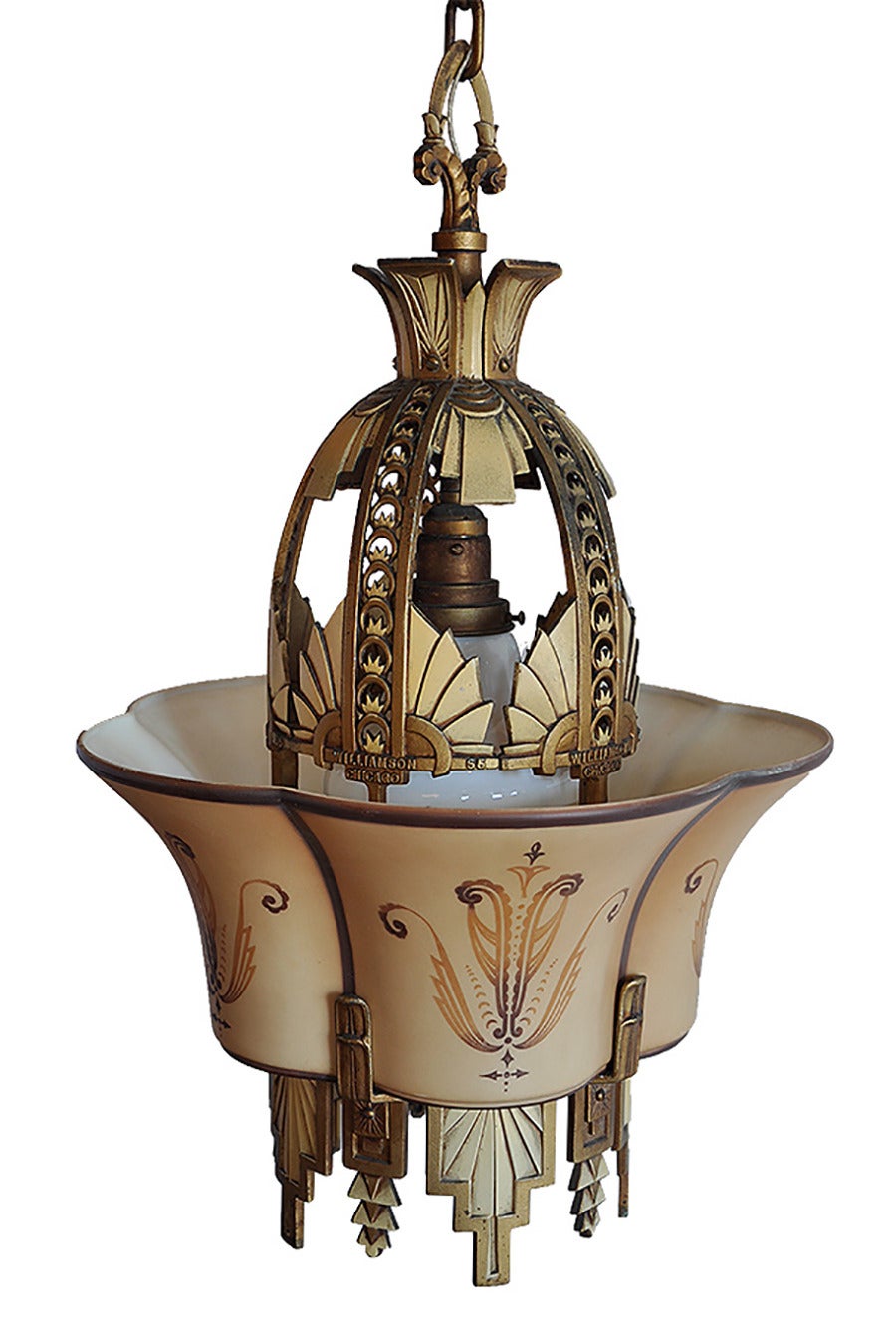 Produced from Chicago’s Premium lighting supplier in the 1930’s, this chandelier is truly rare find of antique art deco glass and a unique change in the ‘slipper shade’ design.  This fixture features one cylindrical shade rather than five separate