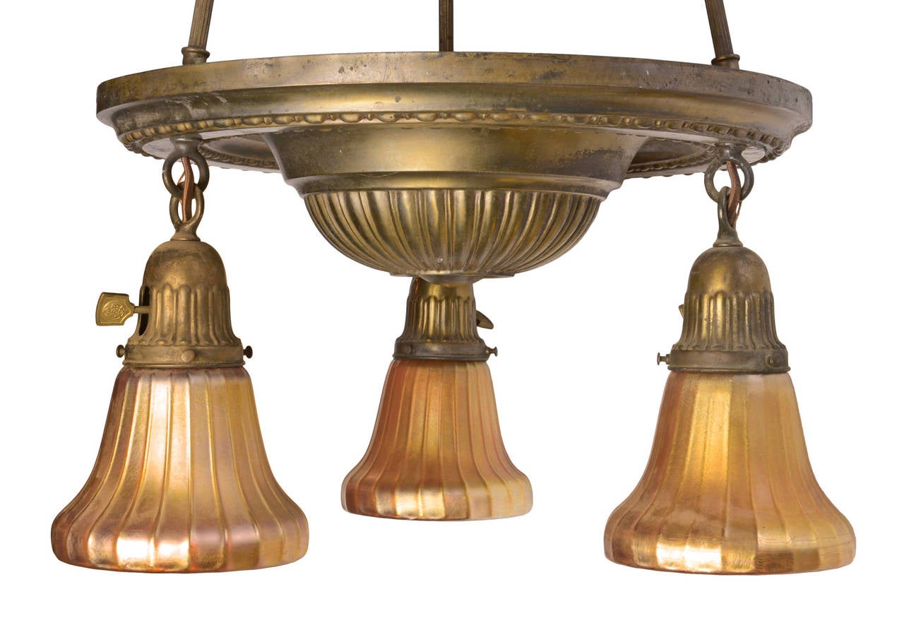 Brass Three Light Fixture featuring Signed Louis Comfort Tiffany Favrile Shades In Excellent Condition In Minneapolis, MN