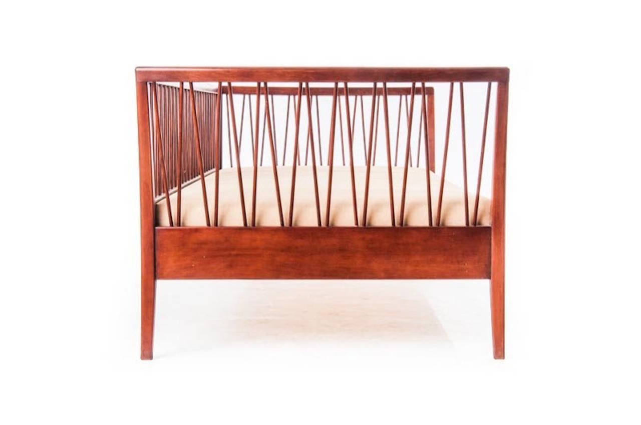 Vintage Danish Modern spindle daybed by Frode Holm. Frame restored with new mattress covered in muslin. This beautiful, unusual piece can be personalized with throw pillows or custom bolsters.

Upholstery services available through Danish teak
