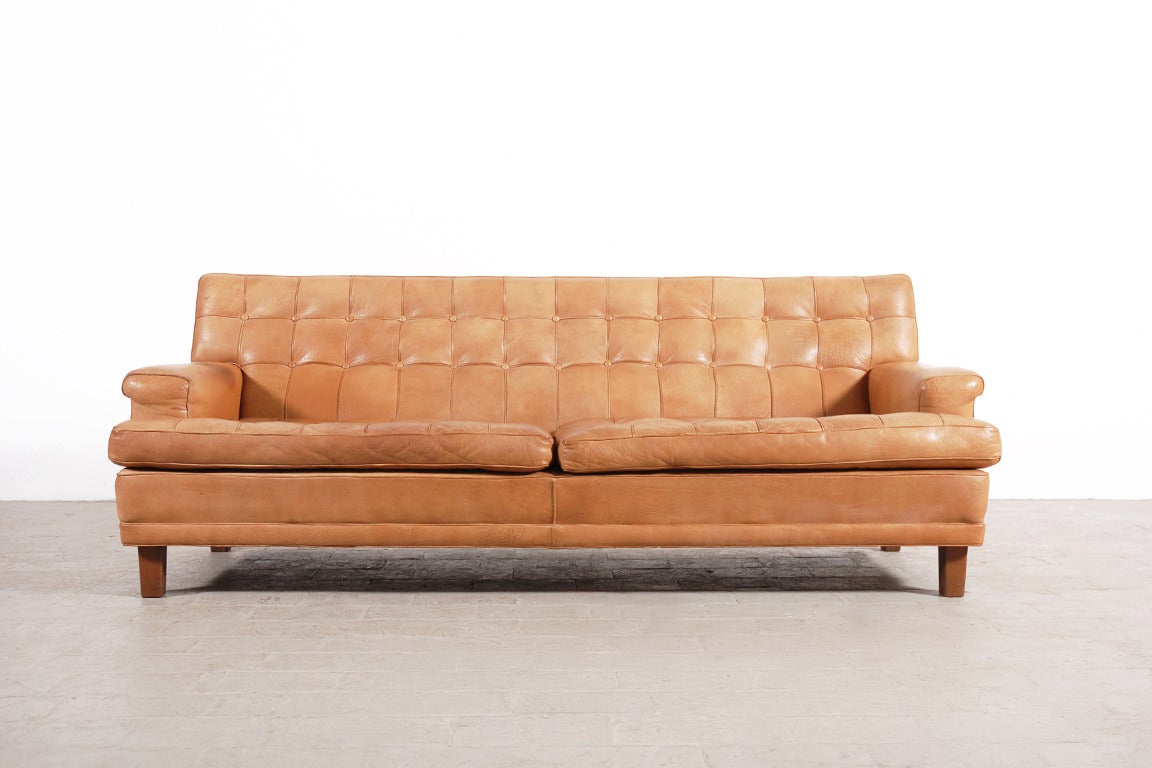 Beautiful three seater sofa designed by Arne Norell and produced by Norell Möbel AB. Circa 1960.
This sofa is extremely comfortable due to this deep and large seat.
The leather is just in incredible good condition and this natural clear color