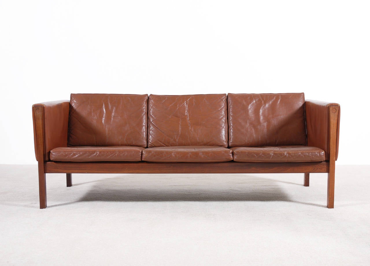 AP-62 Sofa designed by Hans J. Wegner for the manufacturer AP Stolen, Denmark. 1960. Solid Brazilian Rosewood Frame and brown leather.
This sofa is in good original condition, we love how the leather is patinated.
Some marks on armrests.