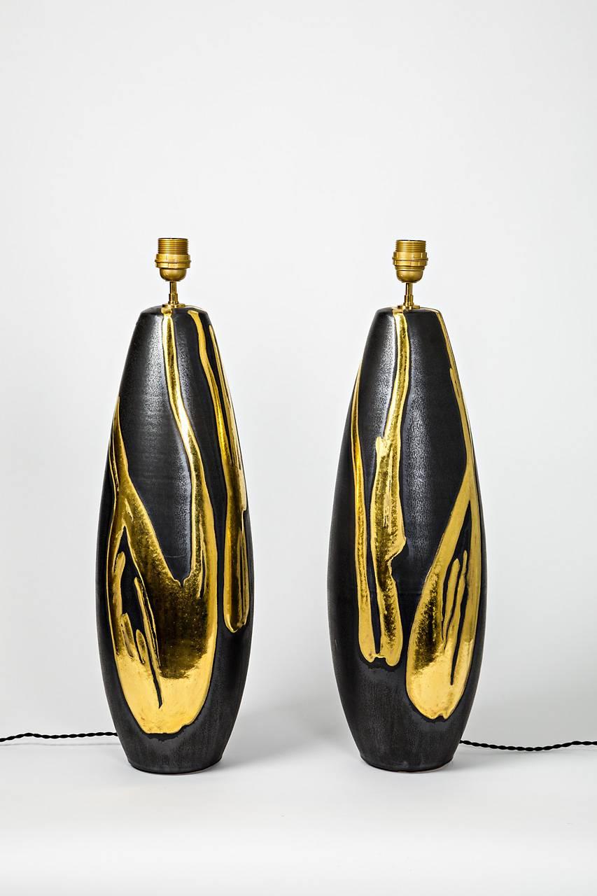 A big pair of ceramic lamps by Jean Cacheleux with gold decoration.
Each piece is signed at the base.
Perfect original conditions.
2016.
Sold with a new European electrical system.