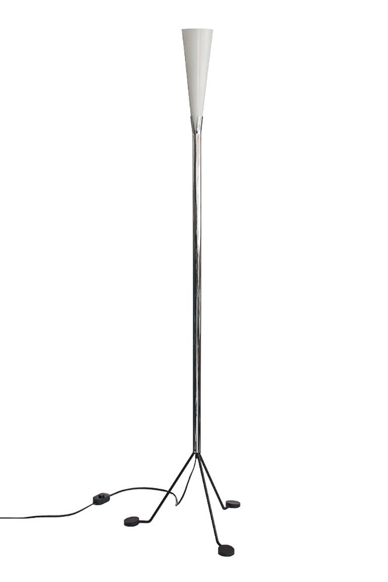 Modernist Italian VeArt floor lamp with tripod black iron base supporting a chrome plated steel stem and white Murano glass shade. Interesting keyhole design where the glass shade is supported within the flared chrome tube. In-line floor switch.