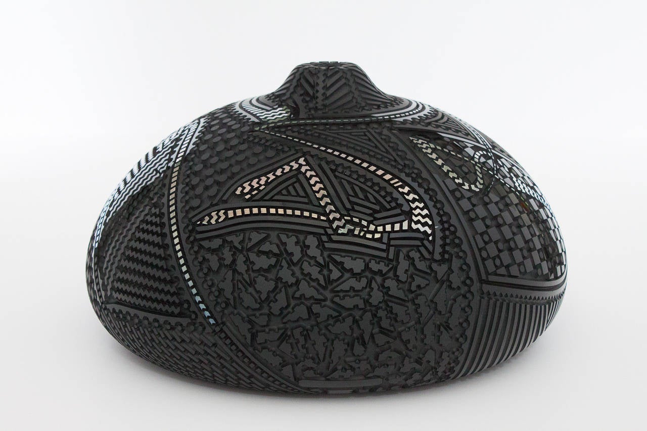 Incredible art glass sculpture by Dick Huss.  Carved black glass vase with high relief etching.  Raised patterns in gloss black, frosted black and metallic silver.  Acquired from Habatat Galleries  (MI).  Signed and dated by the artist, 1986. 