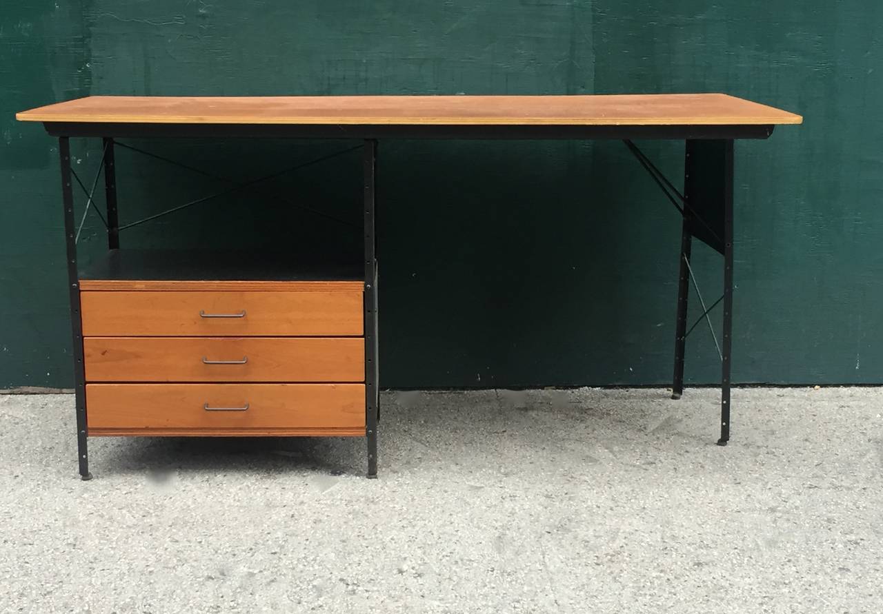 Extremely rare first generation Eames ESU Desk. Retains original label. In original unrestored condition. Normal wear commensurate with age and use. A few marks/colorations on desk surface that can be seen in photos. Walnut veneer desk surface with
