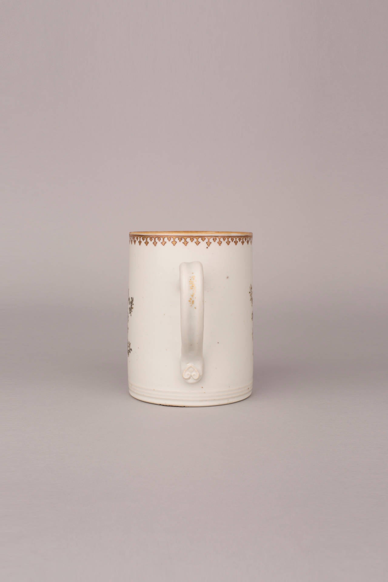 A large Chinese porcelain tankard, decorated in grisaille, iron-red and gilt with ‘The Seamstress’ or ‘The Embroiderer’ seated holding a ball of material with her back to a window with boats, a fisherman seated at the stern beside a cliff with