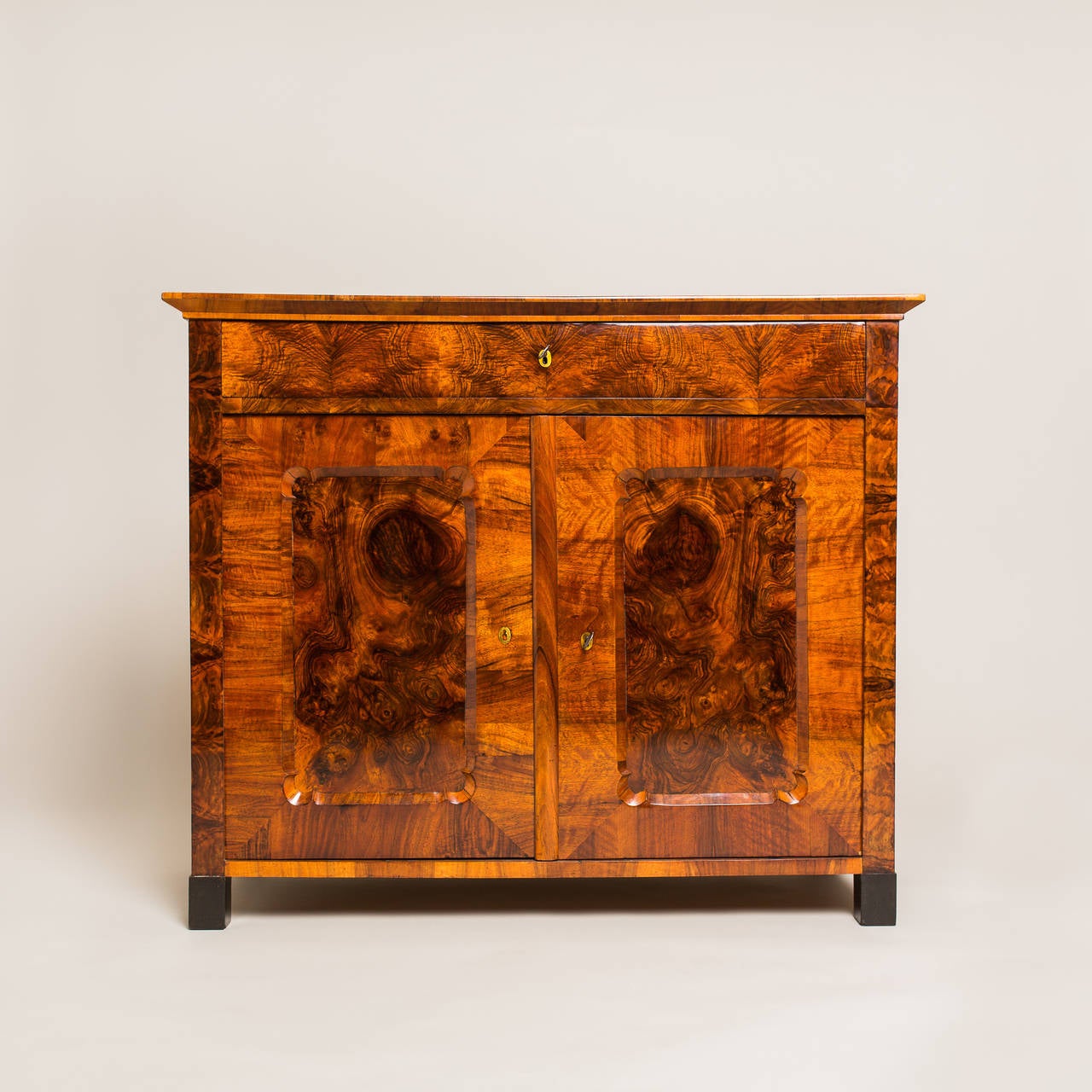 This beautifully arranged half cabinet/sideboard fits effortlessly into any classic or contemporary interior design. Manufactured around 1845, its massive spruce body is topped by a walnut veneer that has been radiantly hand-polished with shellac.
