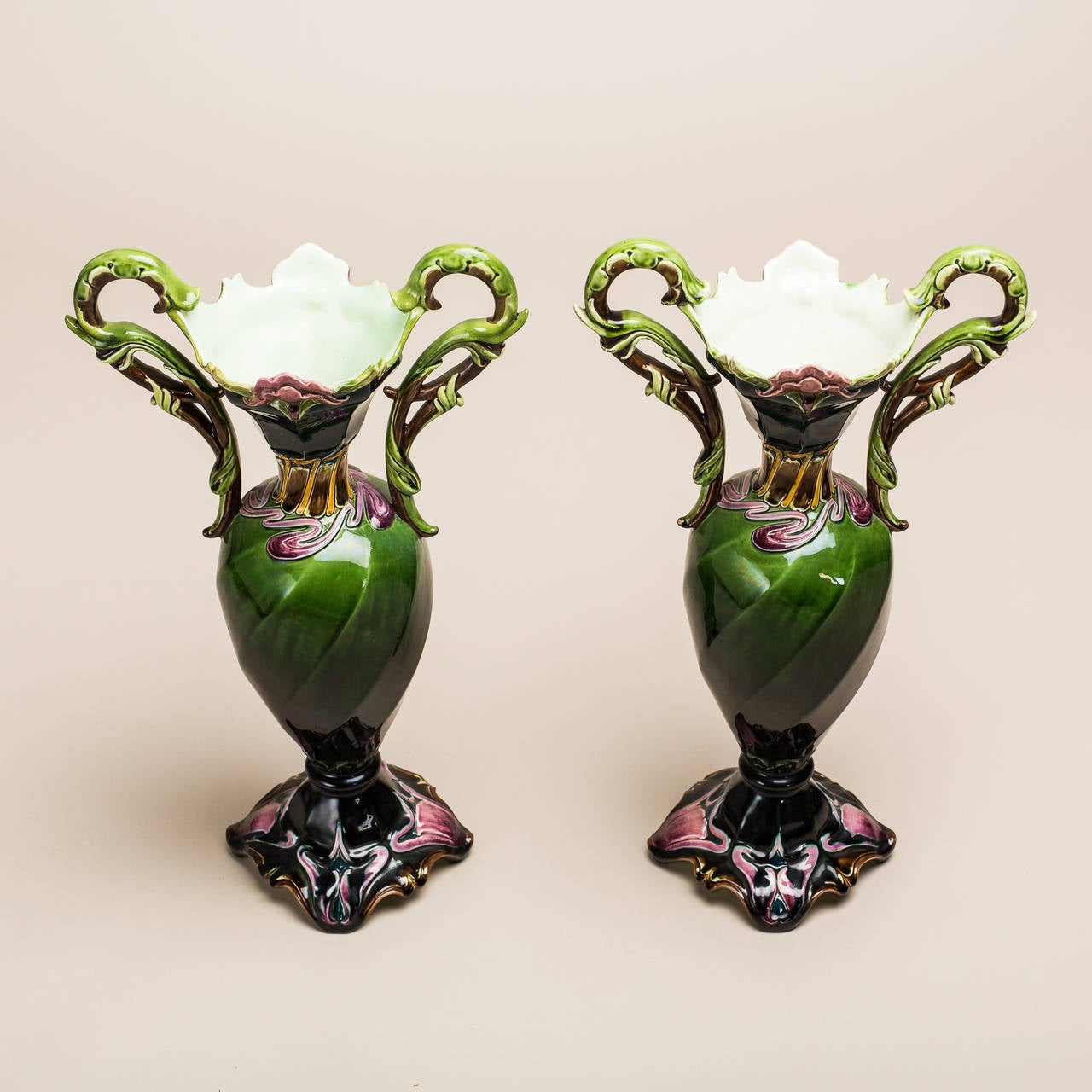 Julius Dressler is a Bohemian company that is known worldwide for their superior ceramic creations. These gorgeous Art Nouveau vases have a smooth natural appearance that is accentuated by its floral style. Detailed handles that bring to mind a