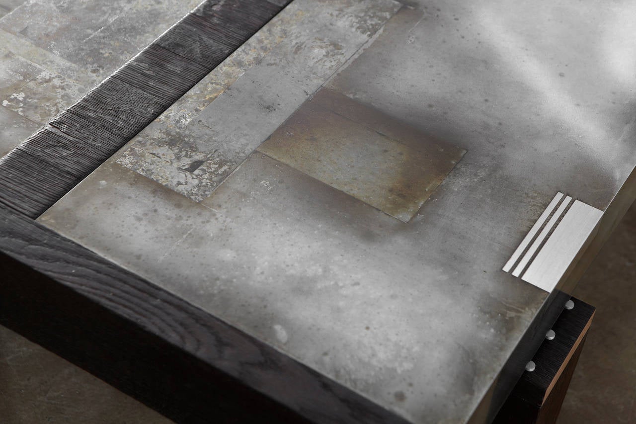 This Studio Roeper original features an acid-etched zinc top in our signature patina style. The industrial character of the metal is complemented by the rich black, textured finish of the charred oak, which is created by torching the wood. Solid