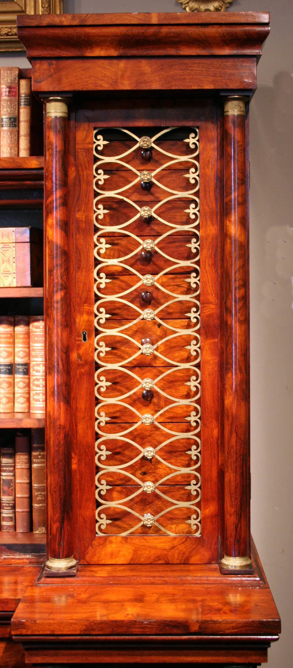 Brass-mounted gonçalo alves collectors cabinet, circa 1815.

Workshop of George Bullock (circa 1783-1818).

Having a moulded cornice above a central recessed section with shelves flanked to each side by rows of small drawers behind scrolling