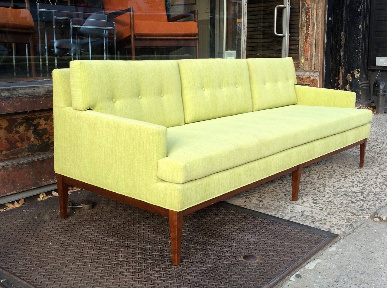 Vintage, 1960s, Mid-Century Modern sofa by Paul McCobb for Directional is fully restored with walnut frame and reupholstered in a plush chenille chartreuse upholstery.