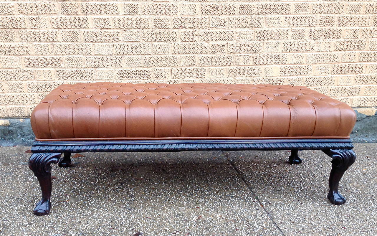 Fully restored tan leather tufted bench or large ottoman with late 19th century, carved mahogany frame.